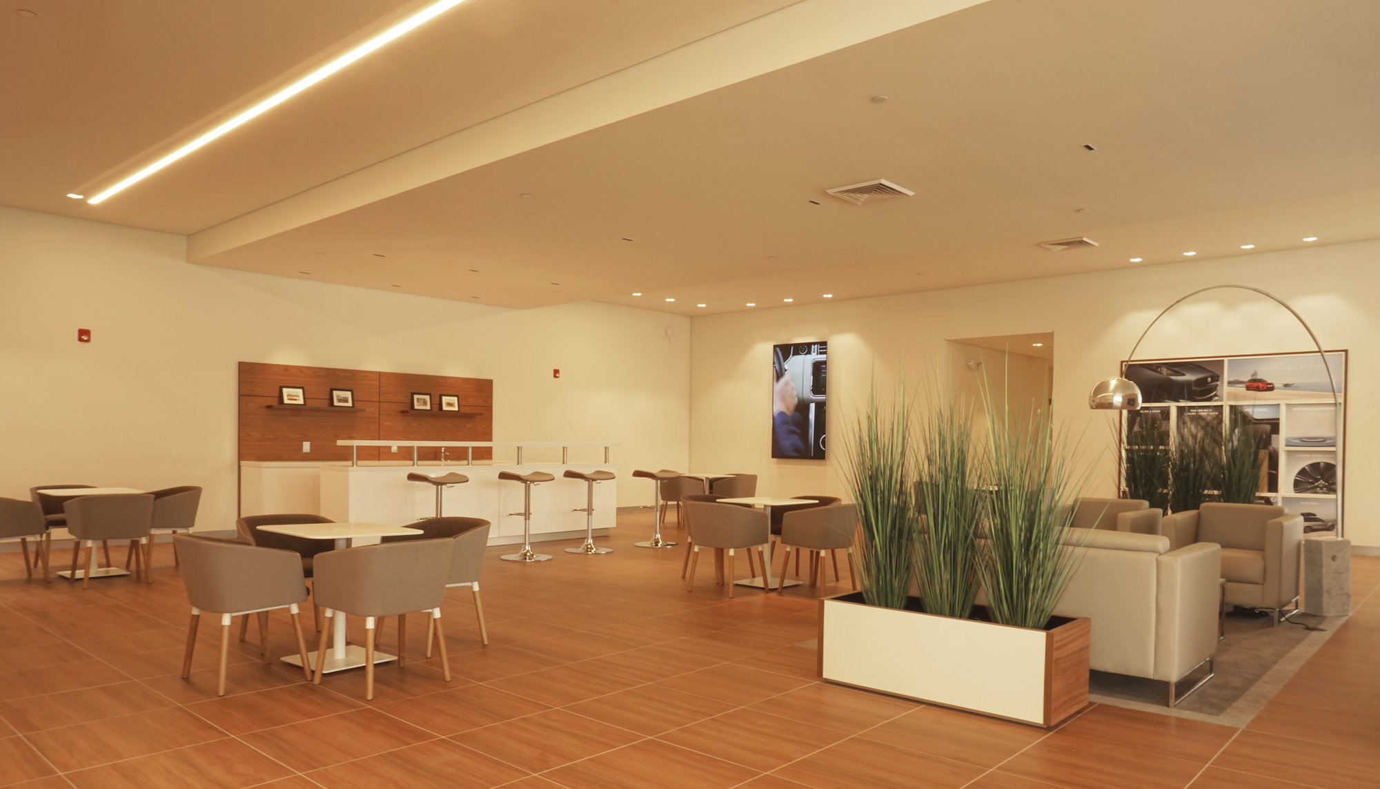 Interior customer lounge at the Jaguar Land Rover dealership featuring integrated seating areas, premium finishes and coordinated showroom environments designed to support customer comfort, brand standards and operational efficiency.