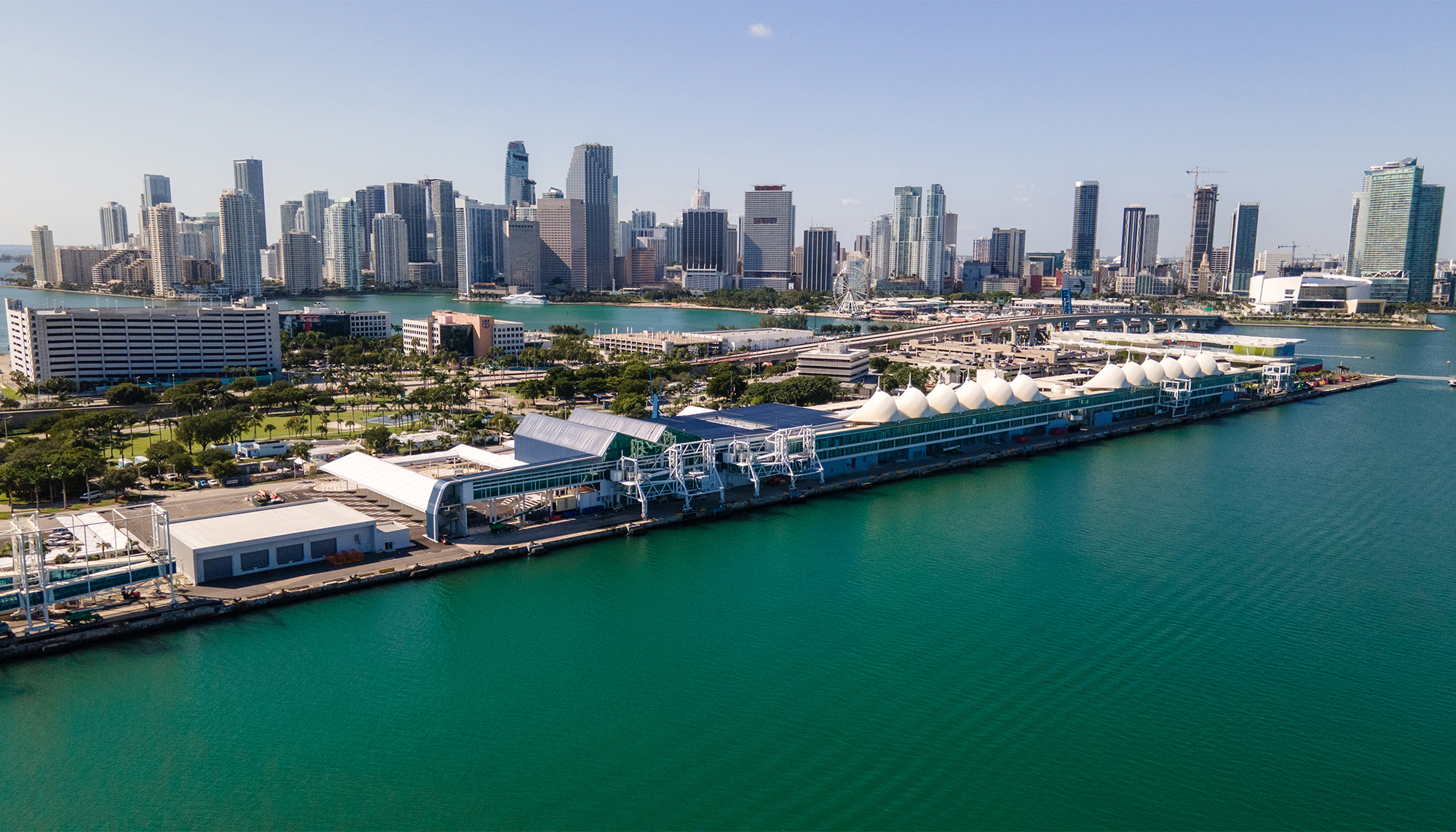 Waterfront cruise terminal featuring steel building construction, passenger embarkation facilities and large-scale transportation infrastructure.