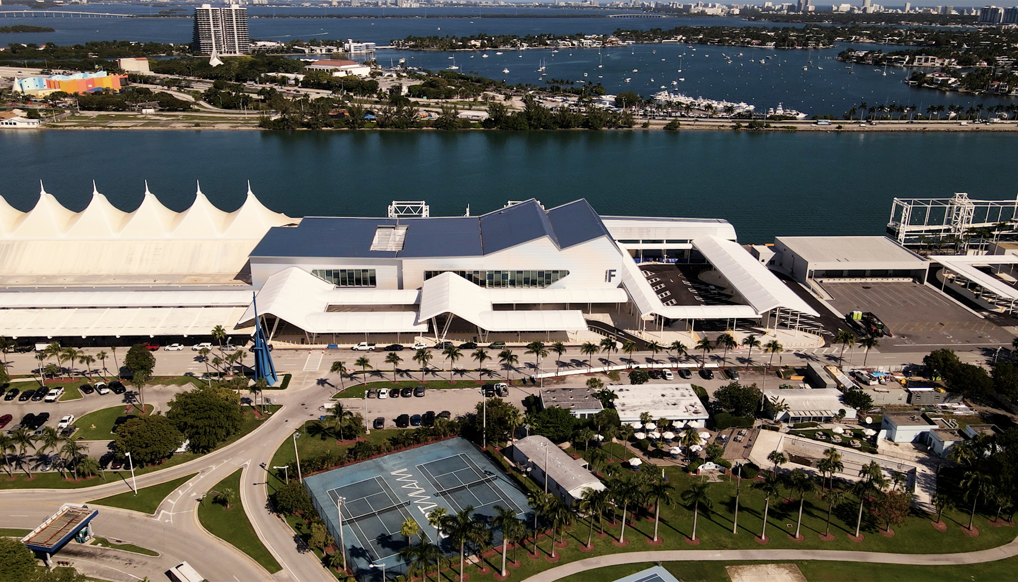 Aerial waterfront view of the PortMiami Terminal F Roof Retrofit featuring an innovative terminal roof system integrated into a large-scale cruise facility through coordinated retrofit planning and structural collaboration.