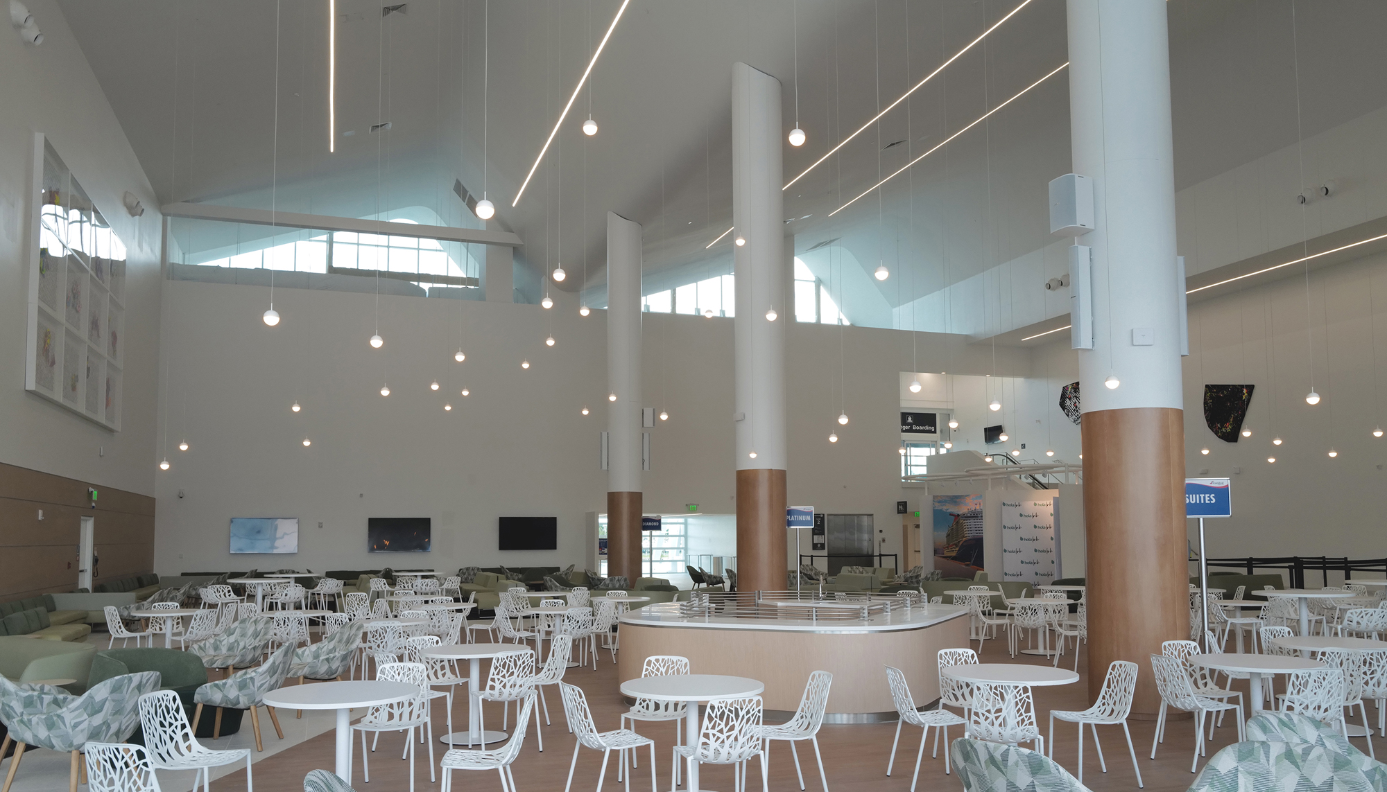 Interior dining and gathering area at the PortMiami Terminal F Roof Retrofit featuring open passenger seating, integrated lighting and a modernized terminal environment designed to improve circulation and traveler experience.