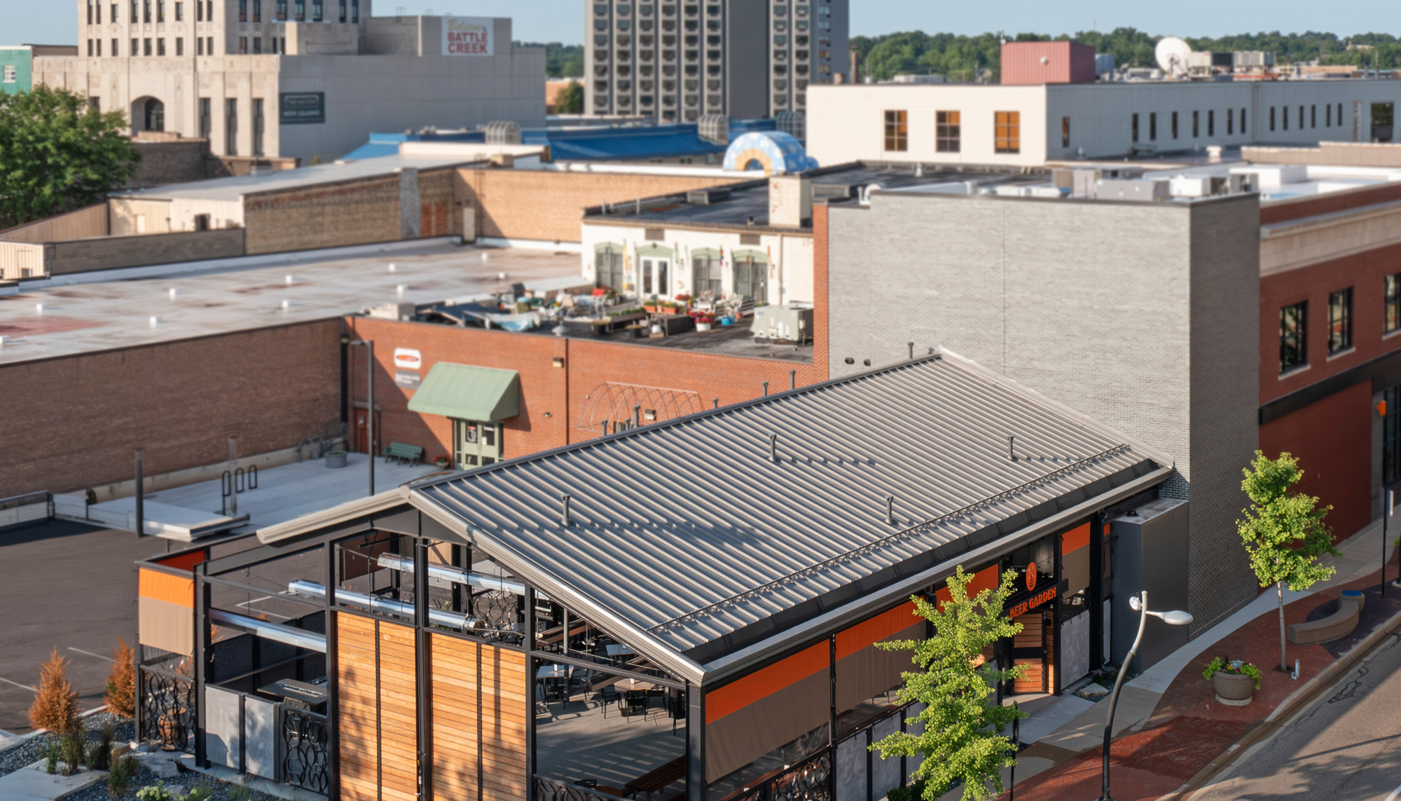 Aerial view of the New Holland Brewing Co. beer garden expansion featuring integrated indoor-outdoor hospitality space, coordinated urban infill design and a flexible year-round environment developed to support dining, entertainment and community engagement.