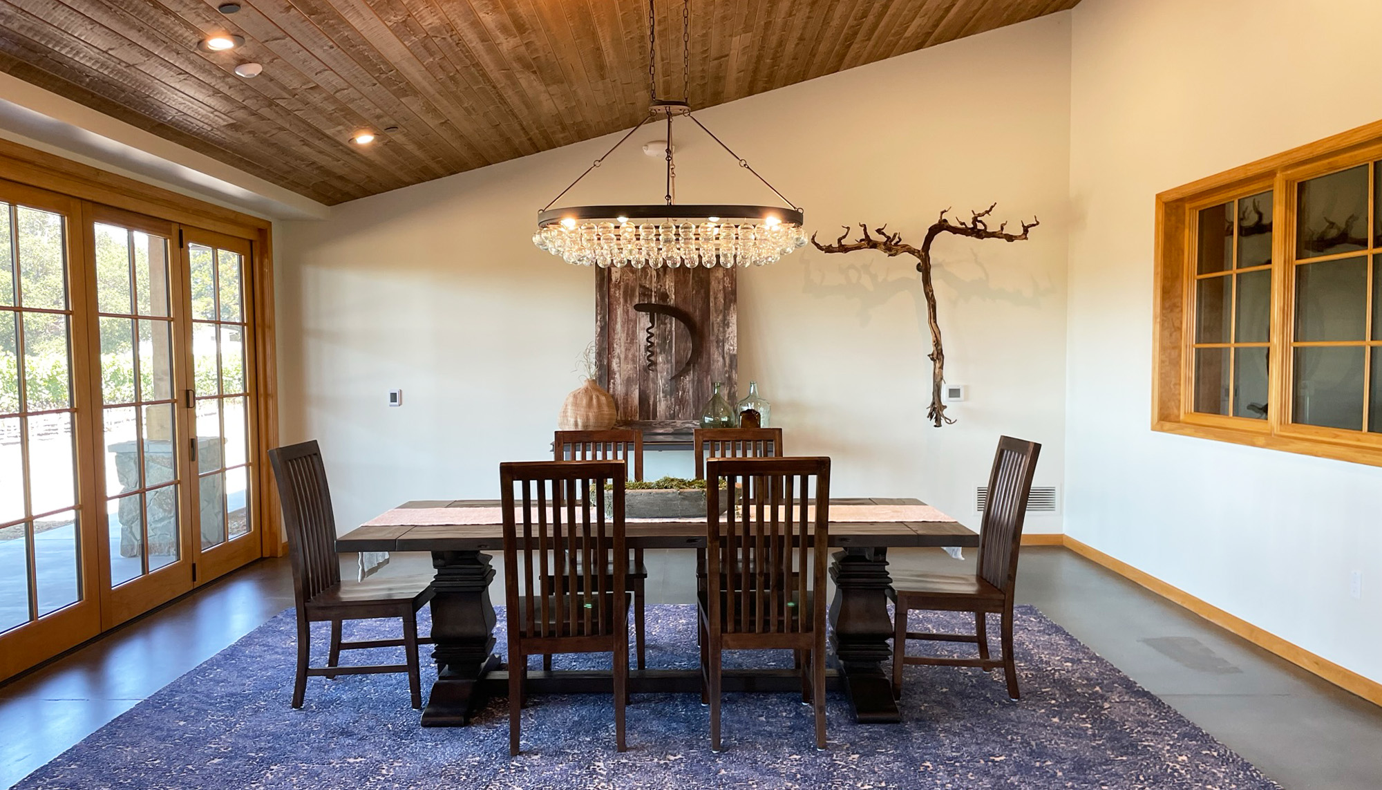 Winery tasting room featuring exposed timber ceiling, hospitality seating and commercial winery facility design.