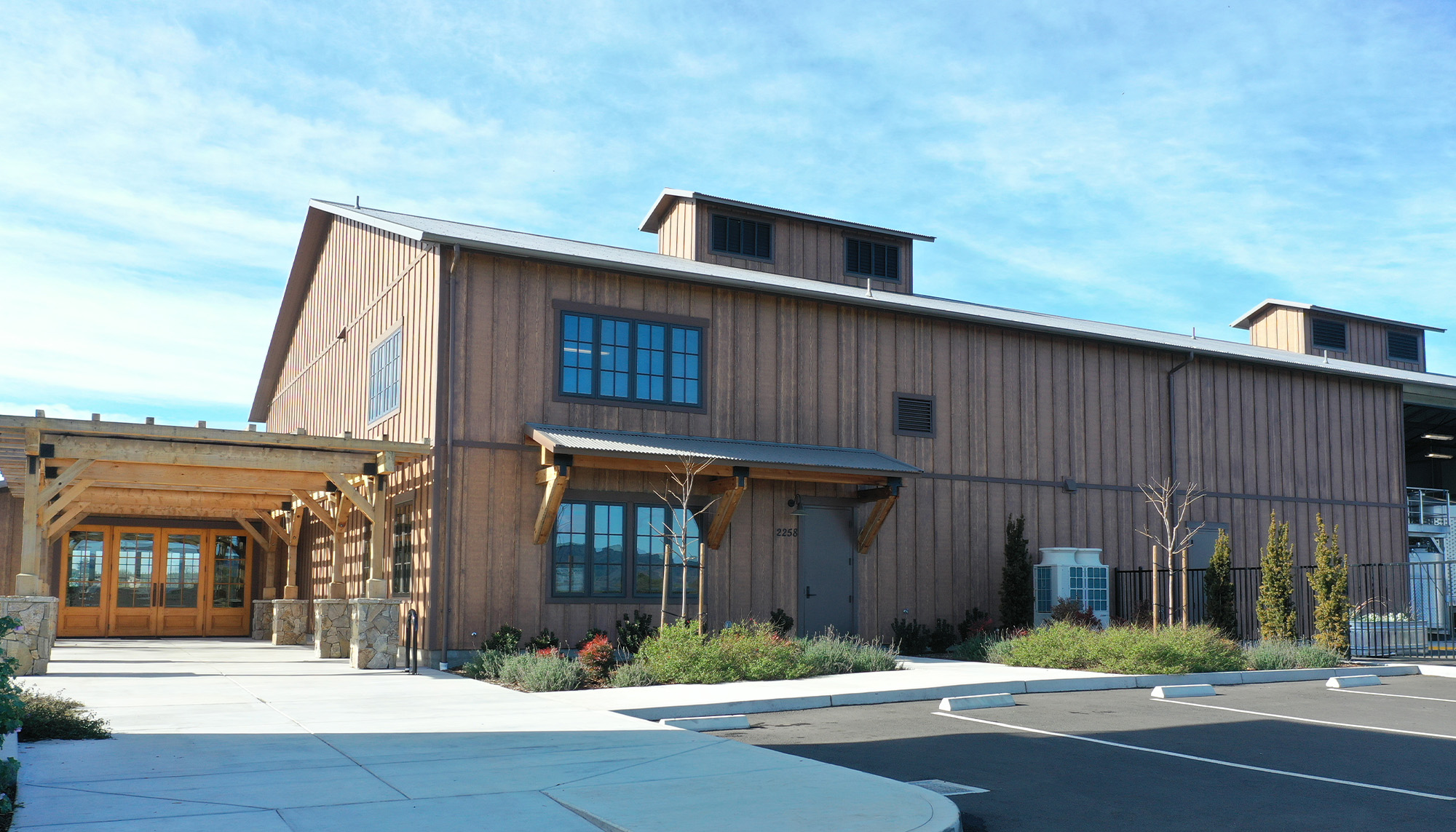 Winery and event facility featuring metal building construction, architectural wood accents and vineyard hospitality design.