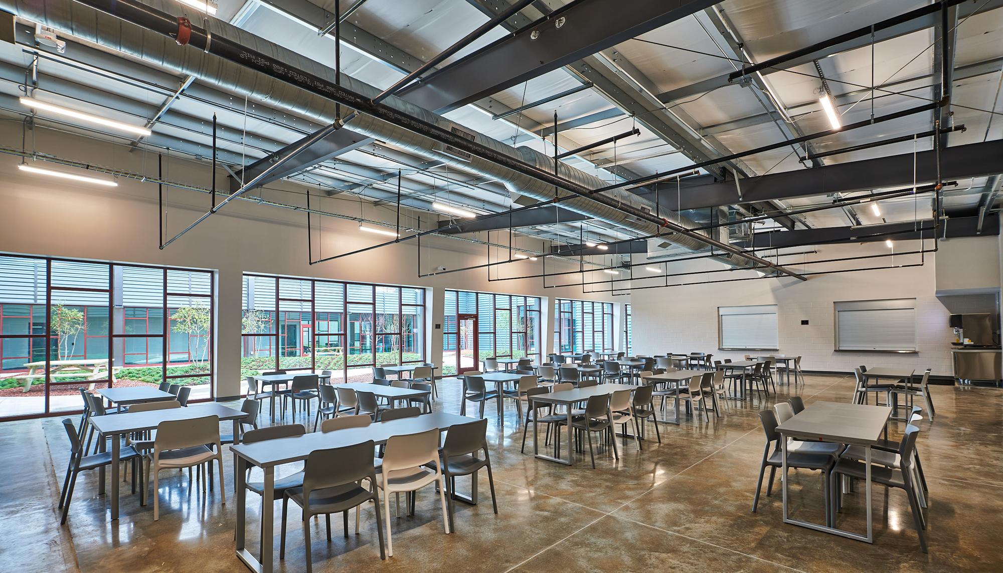 Interior community dining and gathering space at the Firehouse Shelter – New Facility featuring integrated seating areas, open circulation and coordinated support environments designed to provide welcoming daily services and long-term operational functionality.