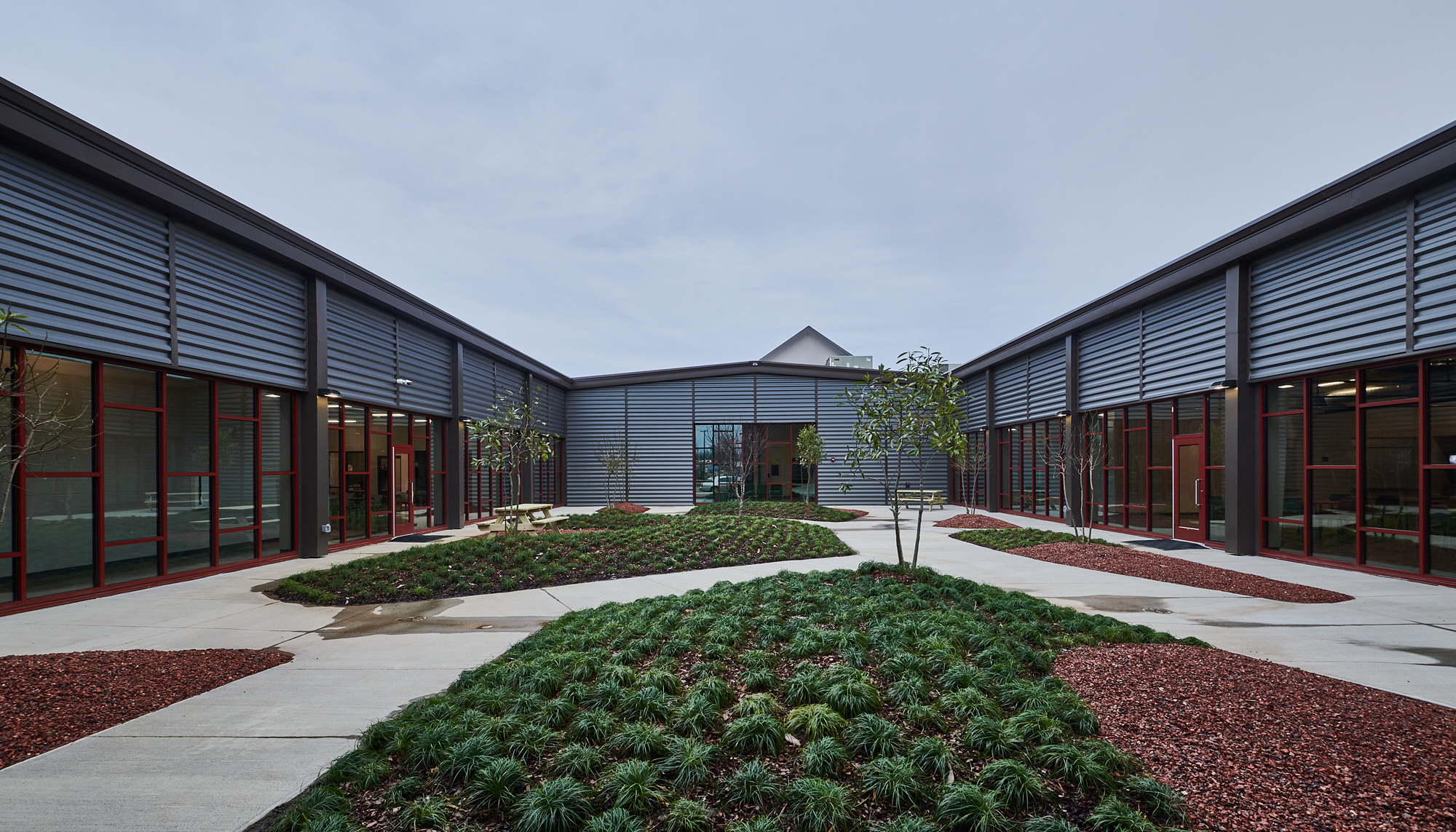 Central courtyard at the Firehouse Shelter – New Facility featuring integrated outdoor gathering space, landscaped circulation areas and a community-focused environment designed to support daily use, resident well-being and long-term operational functionality.