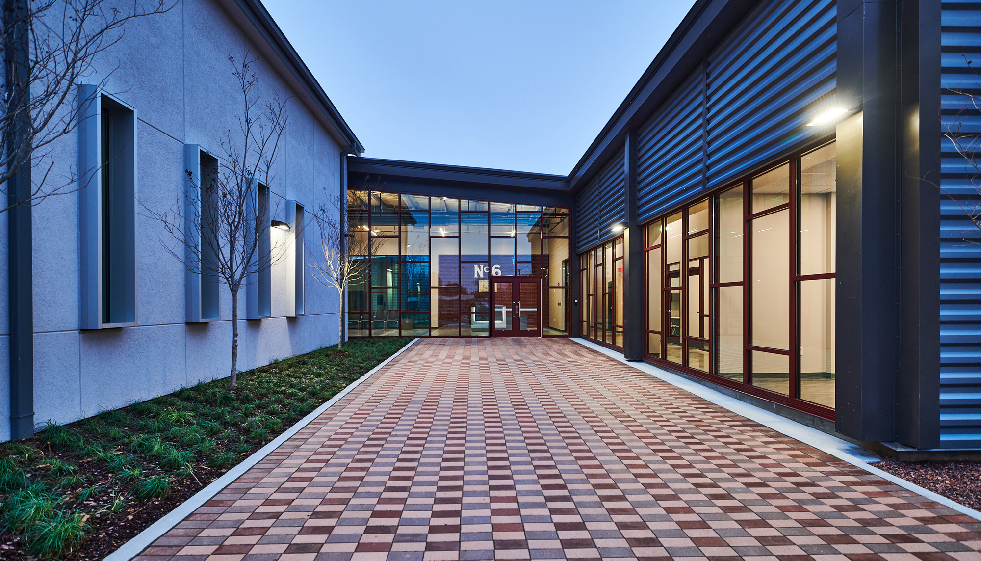 Exterior walkway at the Firehouse Shelter – New Facility featuring integrated circulation space, welcoming architectural design and coordinated community environments developed to support resident comfort, daily services and long-term operational resilience.