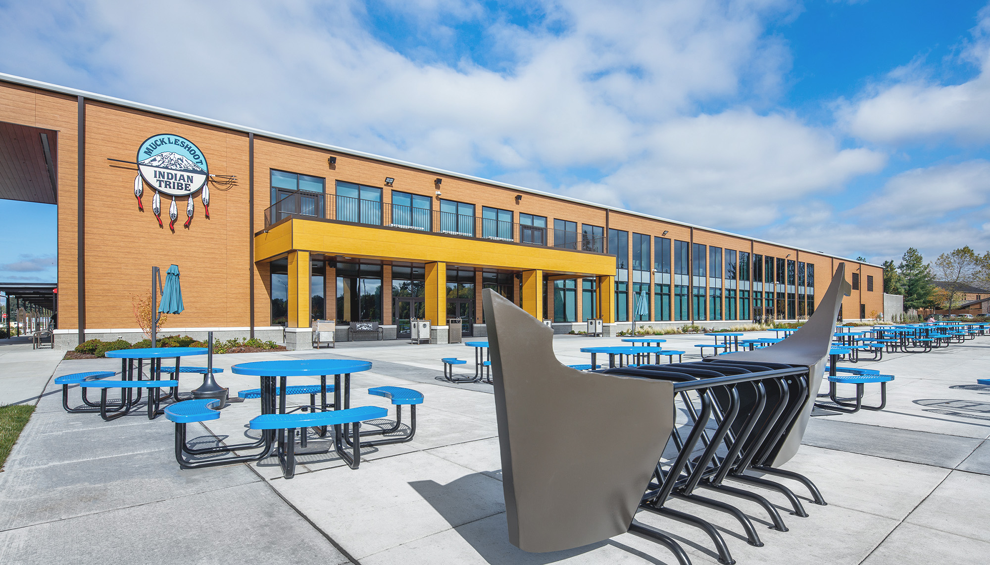 School campus courtyard featuring educational facility construction, outdoor student gathering space and modern steel building design.
