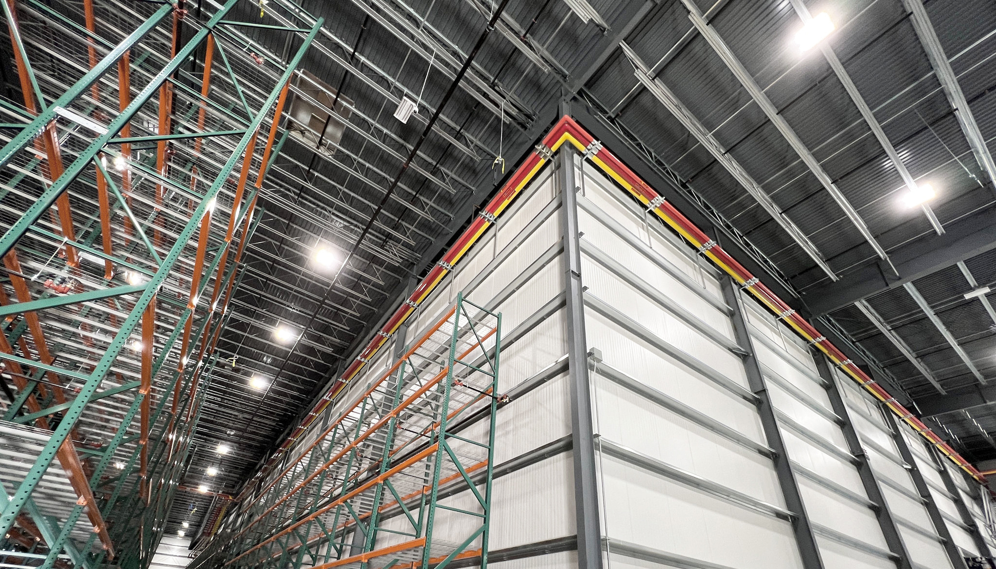 Cold-storage and warehouse infrastructure inside the Northwest Harvest Distribution Center featuring integrated high-density racking systems designed to support efficient food preservation, inventory coordination and rapid distribution.