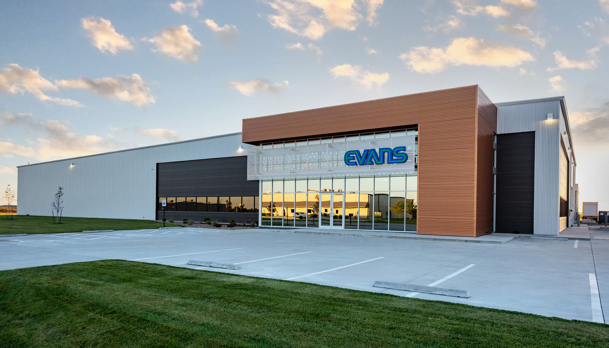 Exterior view of the Evans Building Company headquarters featuring modern metal panel systems and integrated office space.
