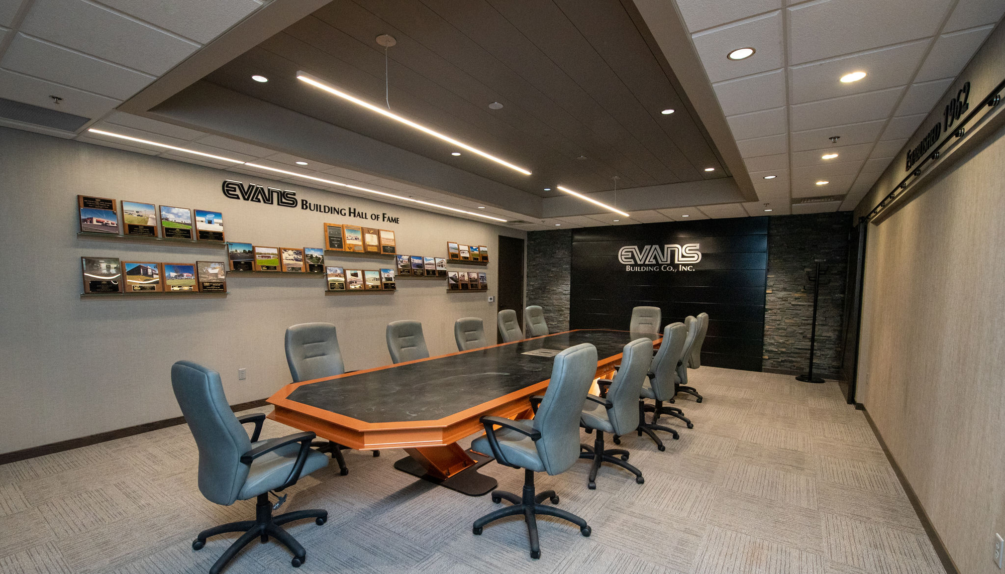 Conference room interior at the Evans Building Company headquarters featuring integrated lighting, modern finishes and collaborative workspace design.