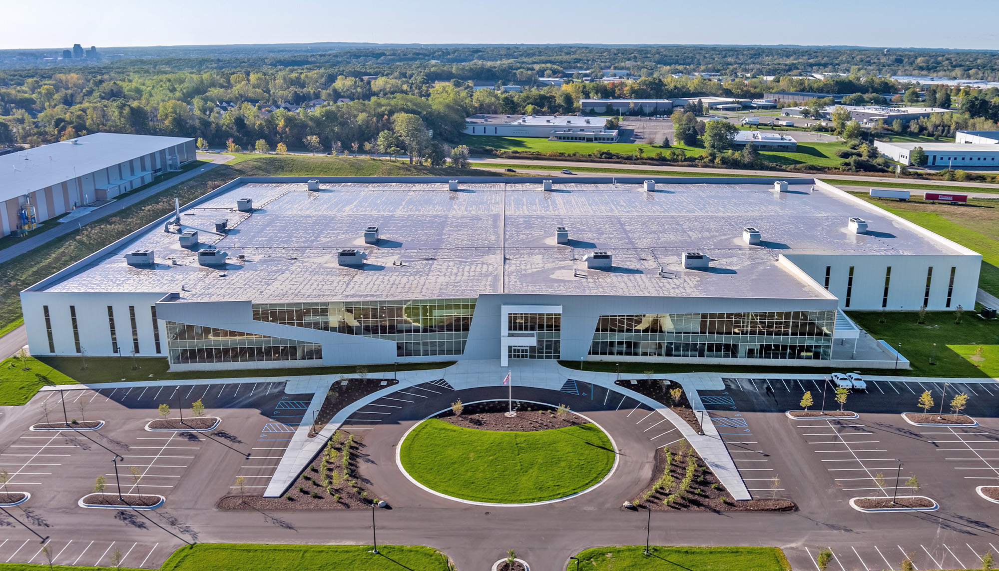 Corporate headquarters facility featuring curtain wall glazing, architectural metal wall panels and large-scale steel building construction.