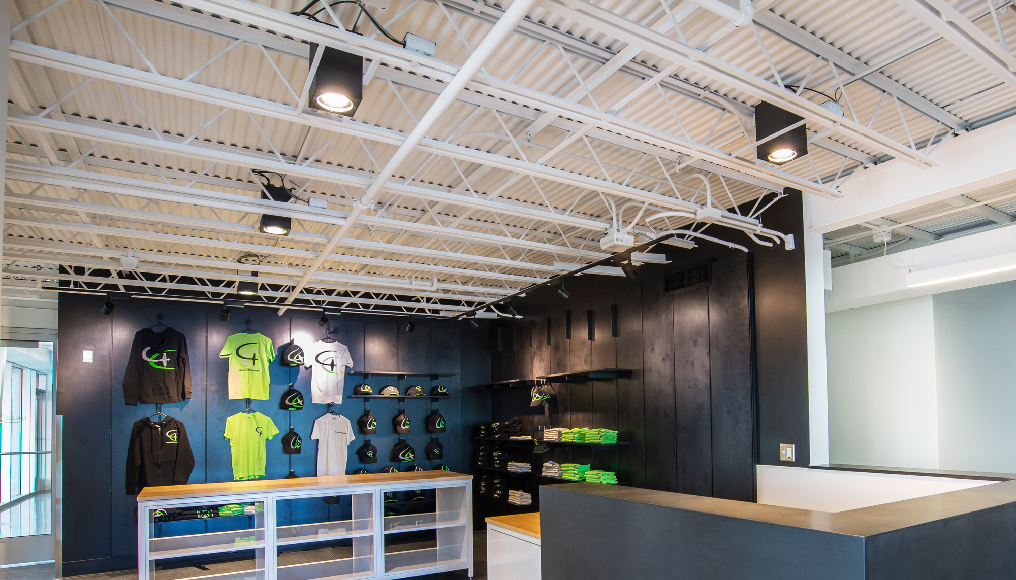 Interior showroom and merchandise area at the Game Aerospace facility featuring integrated customer-facing space, aviation branding and coordinated operational environments designed to support aircraft manufacturing and client engagement.