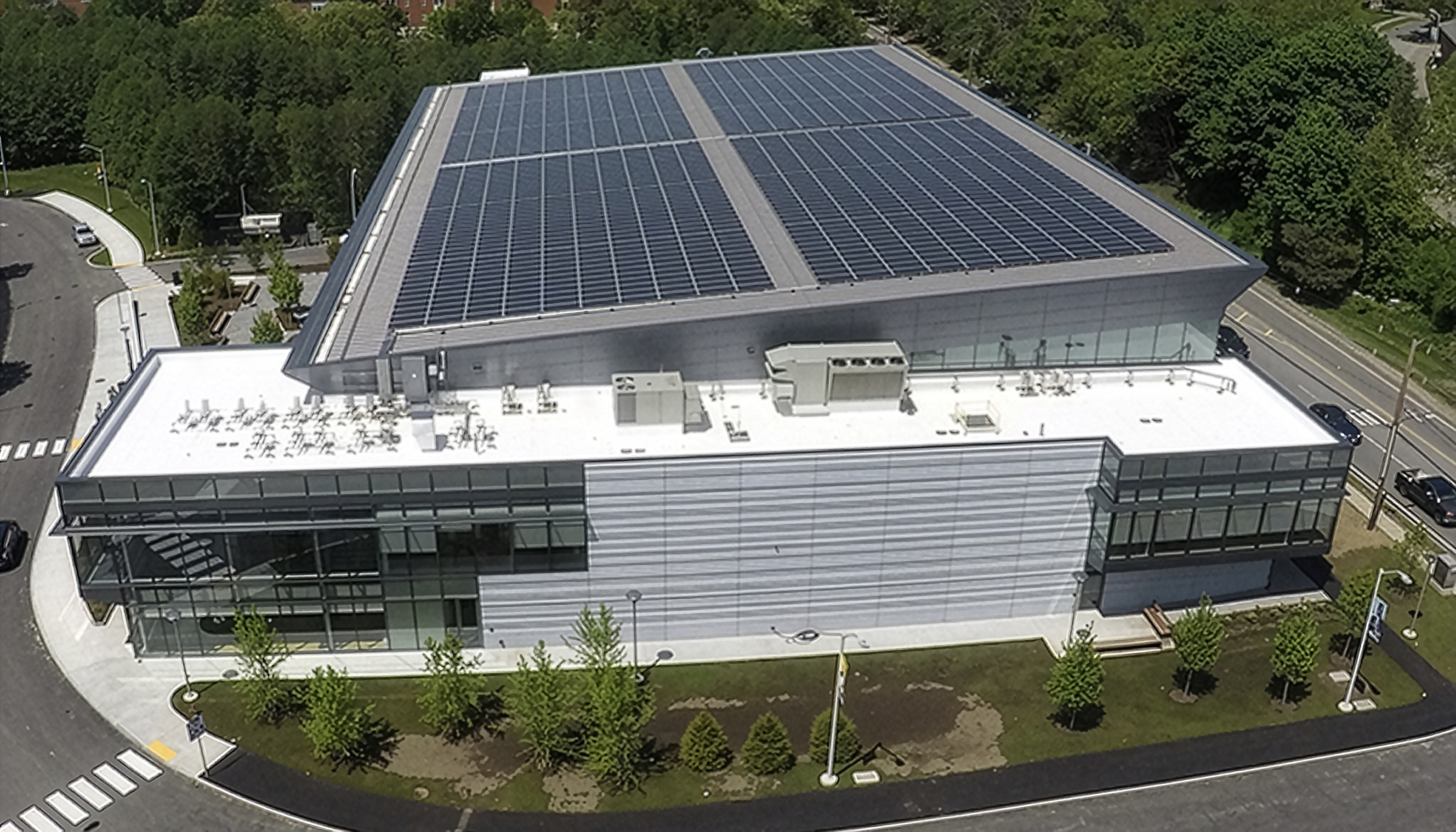 Aerial view of Bentley University’s Sports and Recreation facility featuring rooftop solar panel installation.