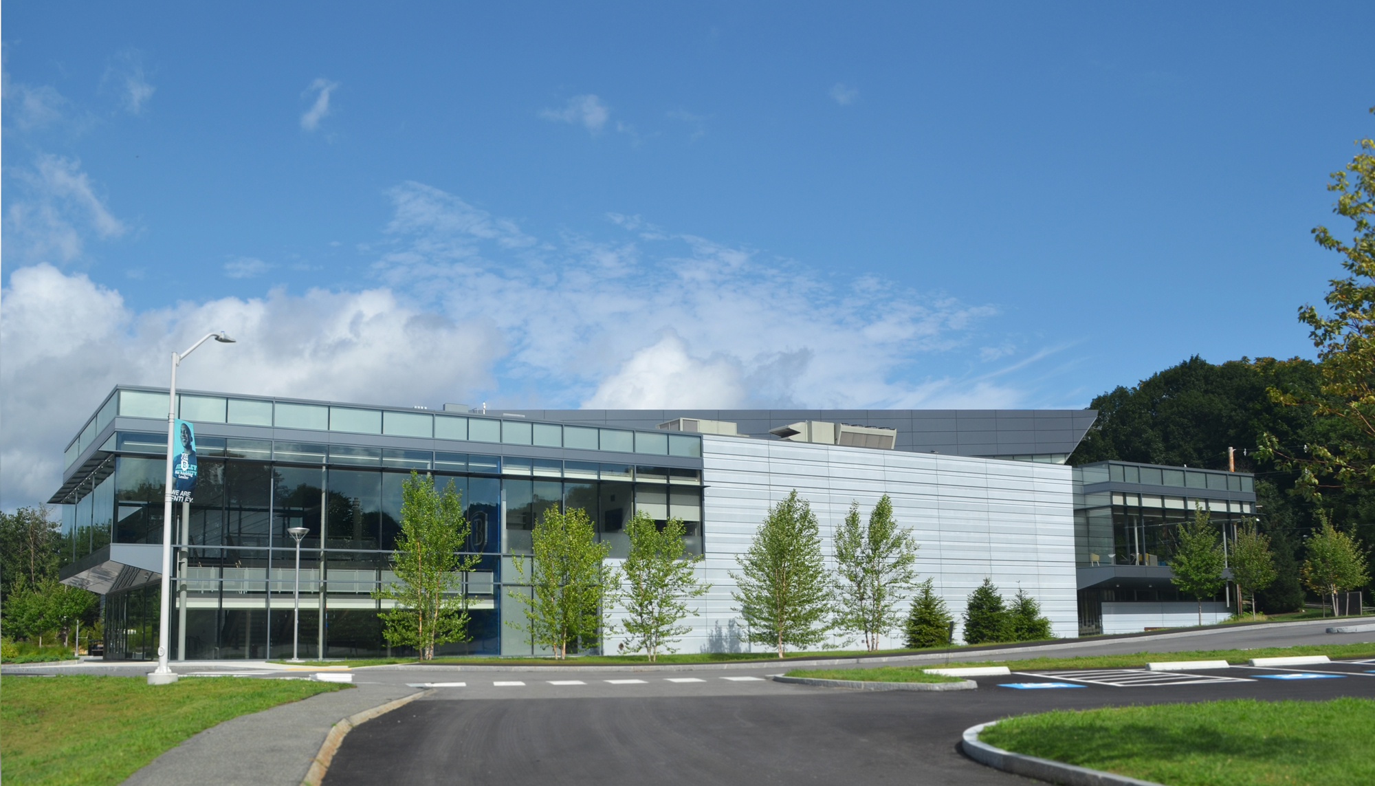 Exterior view of Bentley University’s Sports and Recreation facility with glass curtainwall and metal panel facade.