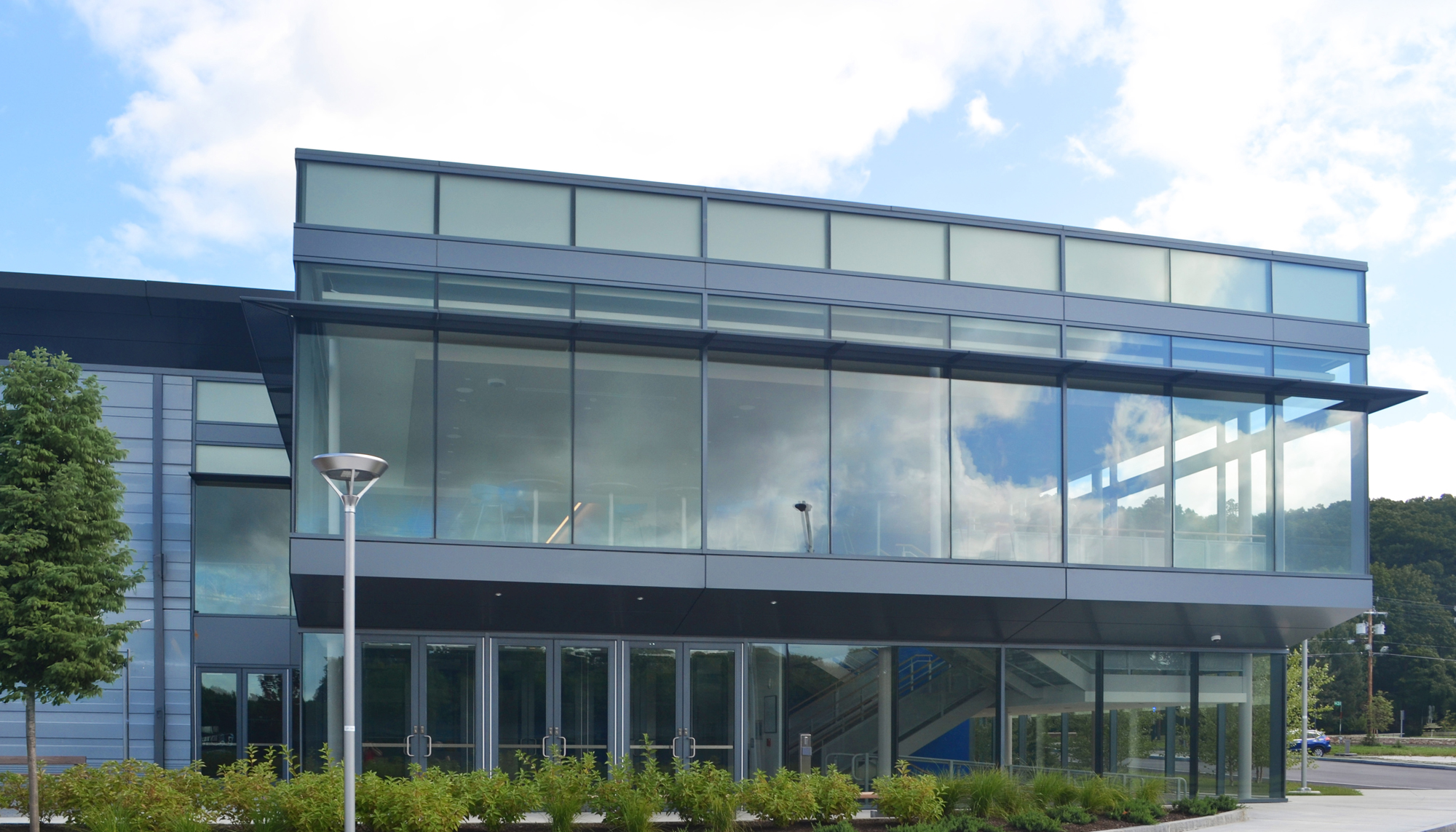 Glass entrance facade at Bentley University’s Sports and Recreation facility featuring expansive curtainwall design.