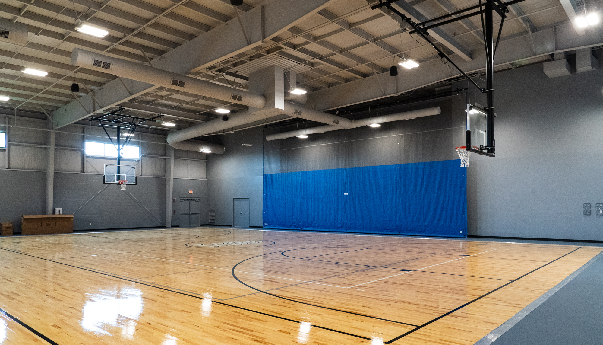 Interior gymnasium space at the Lifeline Ministries HUB featuring integrated recreation areas, flexible programming space and coordinated community environments designed to support education, athletics and year-round engagement.