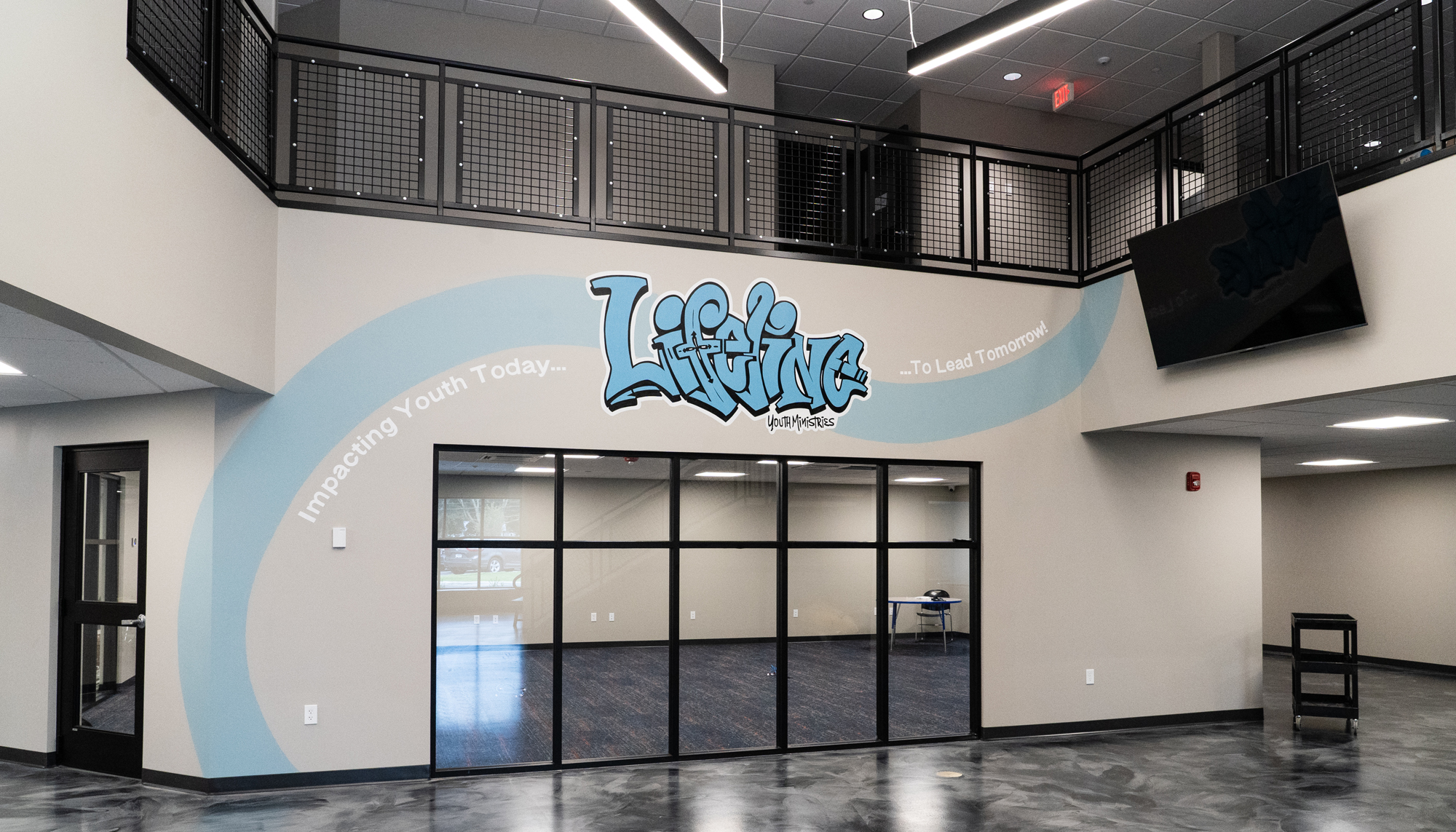 Interior community space at the Lifeline Ministries HUB featuring integrated circulation areas, flexible gathering environments and coordinated multi-use design developed to support students, families and year-round community programming.