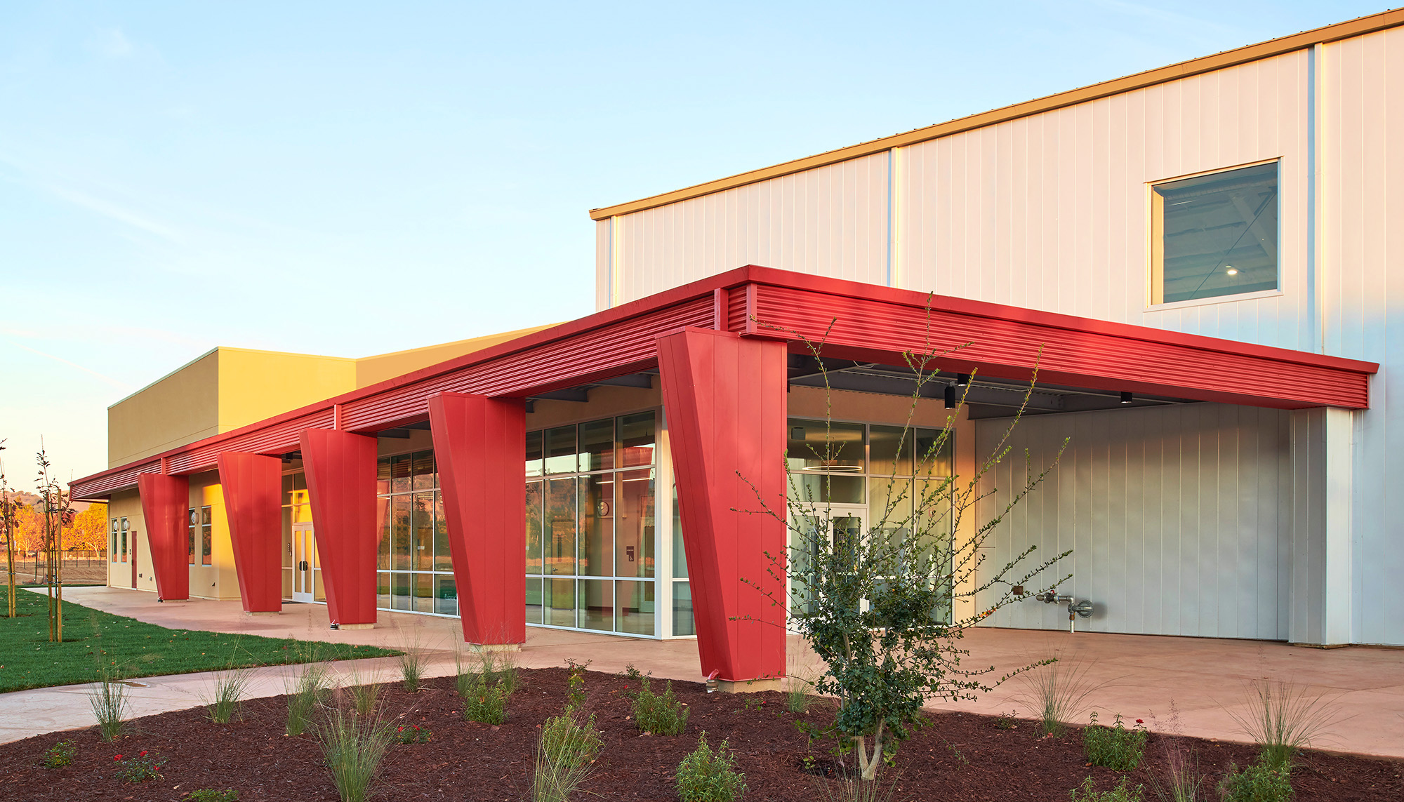 Recreation facility entrance with architectural metal panel systems, curtain wall glazing and community center design.