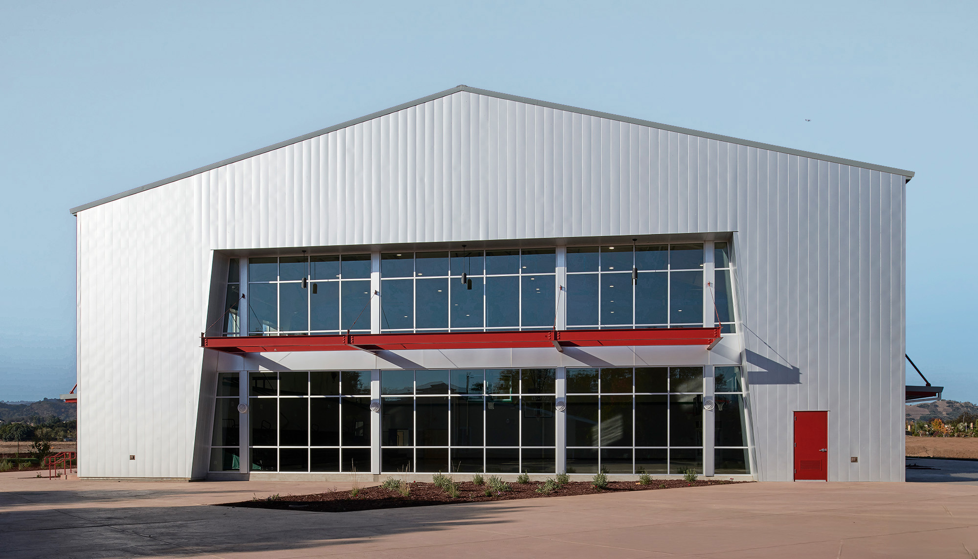 School featuring clear span steel framing, curtain wall glazing and pre-engineered metal building construction.
