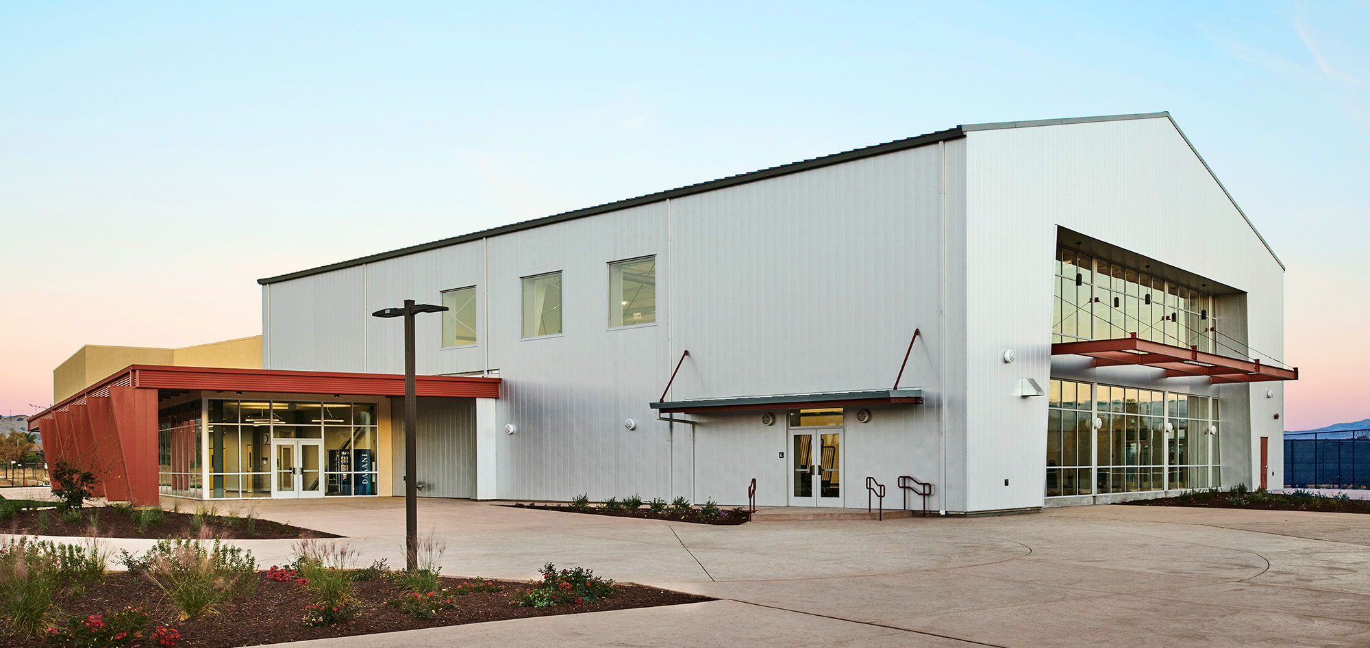 Community recreation center featuring architectural metal wall panels, storefront glazing and steel-framed facility construction.