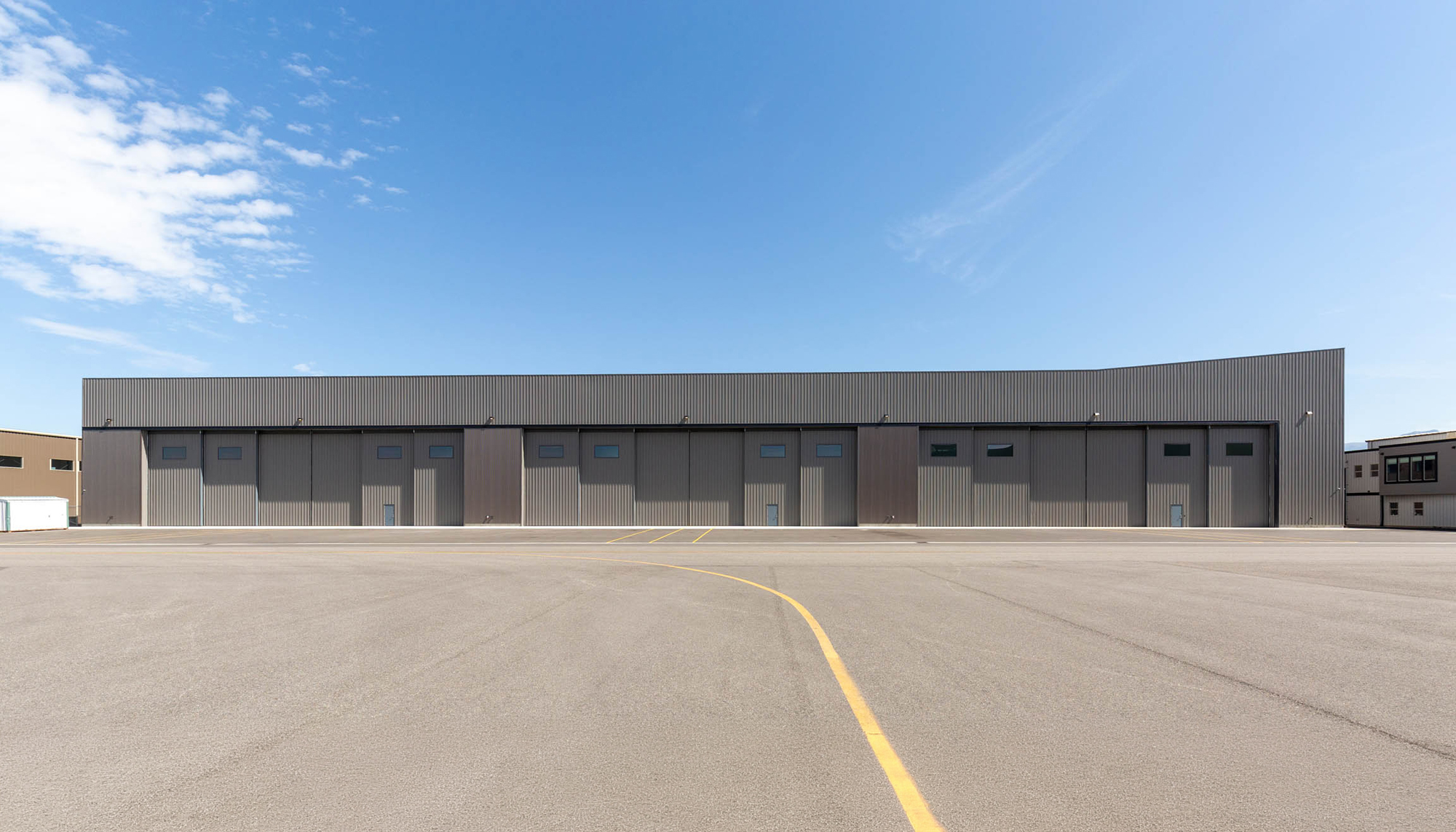 Aircraft hangar complex featuring steel building systems, multiple hangar bays and aviation facility construction.
