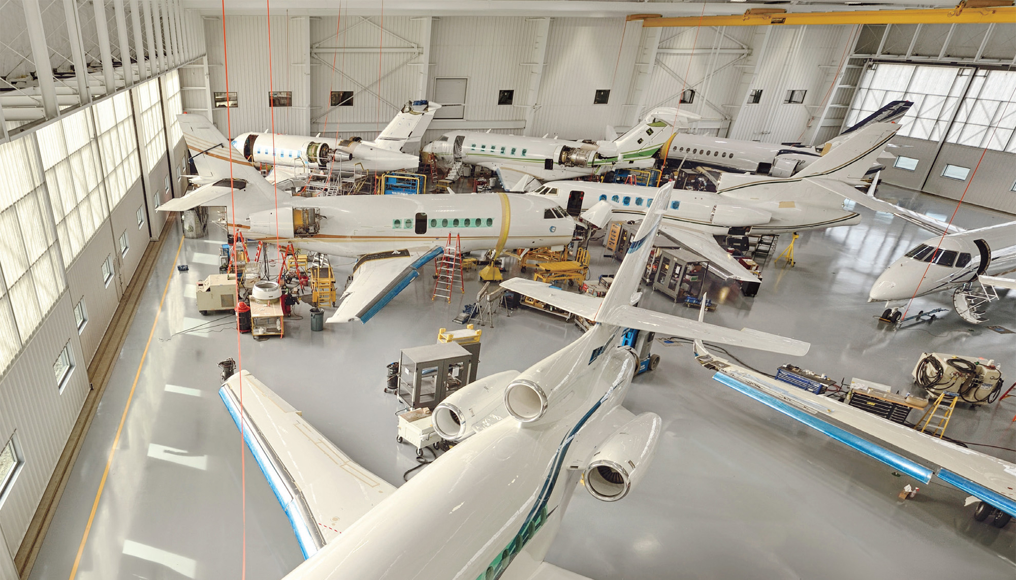Interior view of the Duncan Aviation Lincoln Maintenance Hangar featuring multiple aircraft positioned within a large clear-span maintenance environment designed to support integrated servicing operations, efficient workflow coordination and expanded aviation capacity.