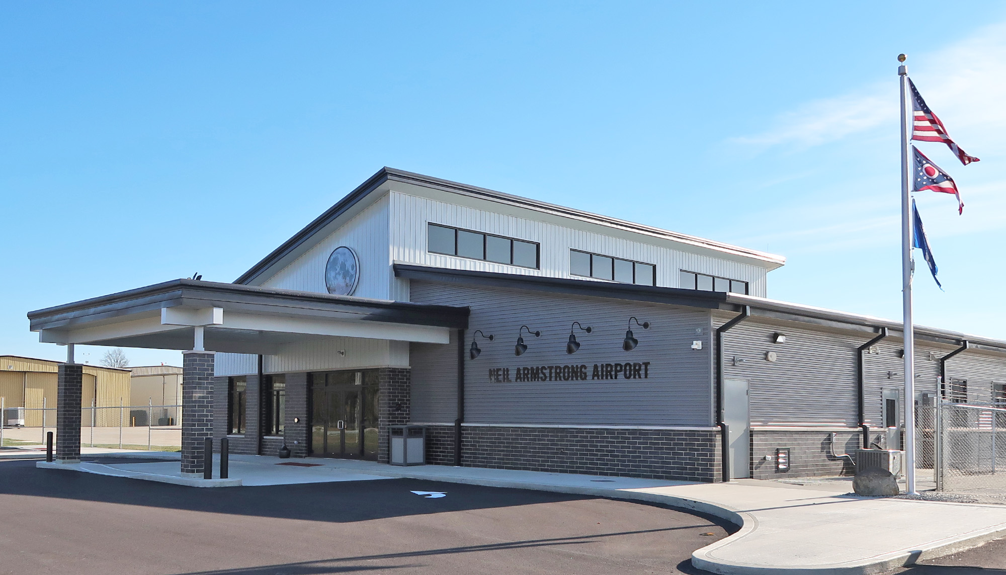 Neil Armstrong airport terminal building with metal wall panel systems, passenger entrance canopy and commercial aviation facility design.