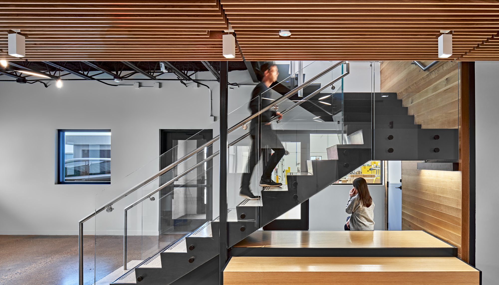 Interior office and collaboration space at the WACO Aircraft Corp. facility featuring integrated circulation, modern workspace design and coordinated environments developed to support aviation manufacturing, customer engagement and operational collaboration.
