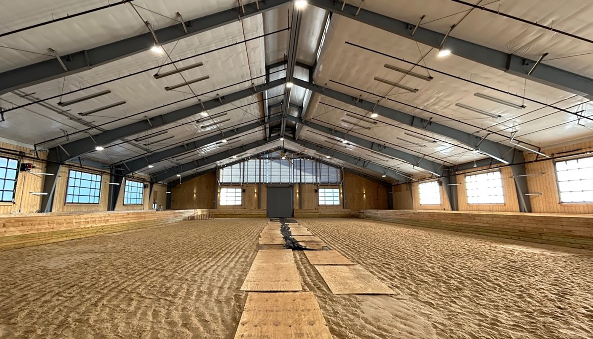 Interior equine training and evaluation arena at the Marion duPont Scott Equine Medical Center featuring a controlled year-round environment designed to support diagnostics, rehabilitation and integrated veterinary care for athletic horses.