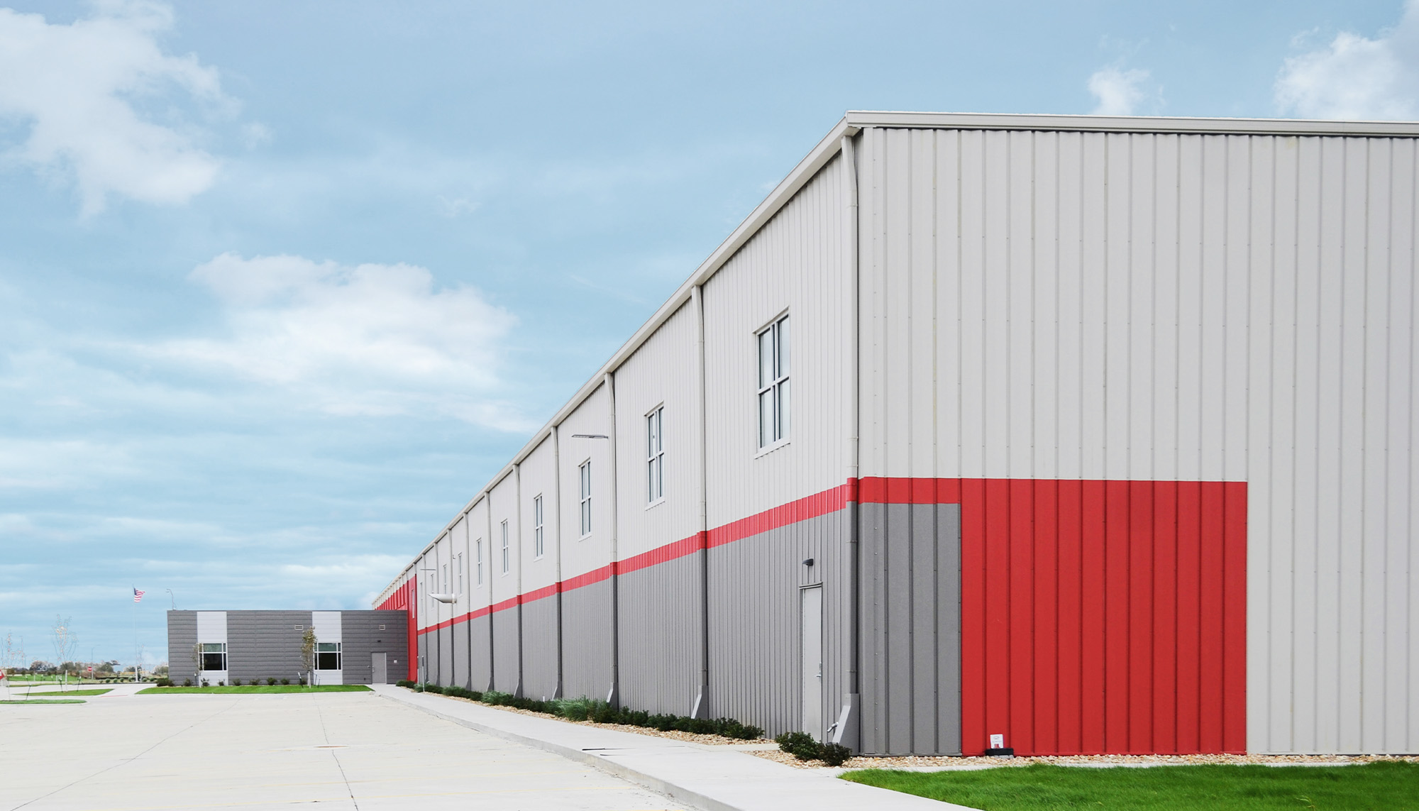 Industrial warehouse building featuring metal wall panel systems, pre-engineered steel construction and commercial storage operations.