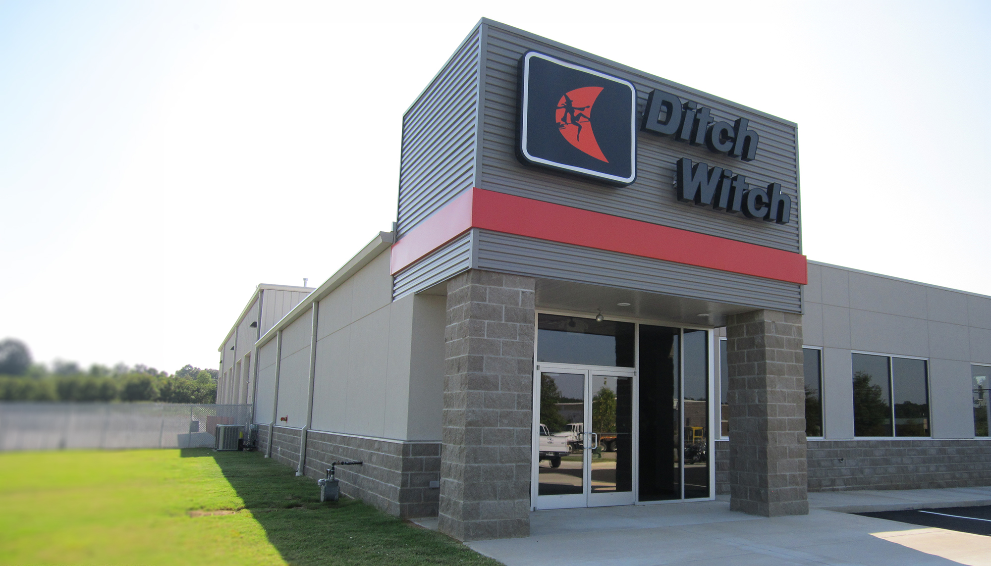 Main entrance of the Ditch Witch Mid South facility featuring branded storefront and metal building exterior.