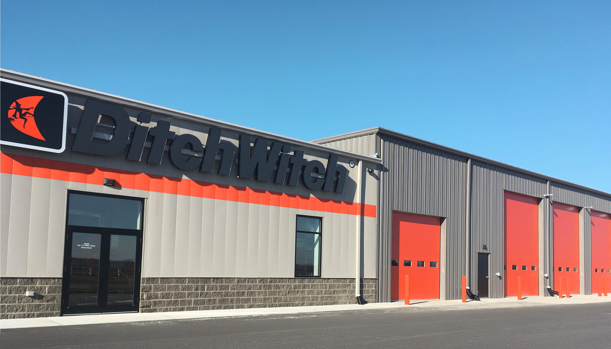 Exterior view of the Ditch Witch of Minnesota & Iowa facility featuring branded facade and multiple service bay entrances.