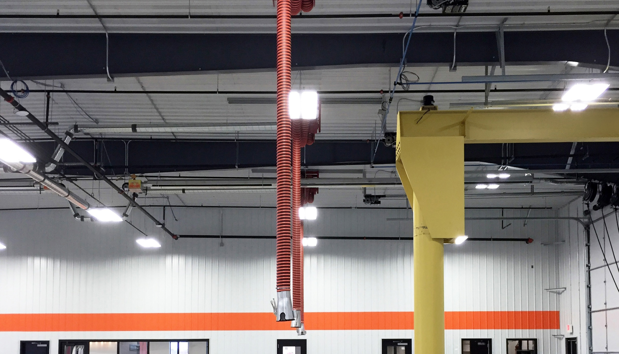 Interior service area at the Ditch Witch of Minnesota & Iowa facility featuring exposed structural systems and overhead utilities.