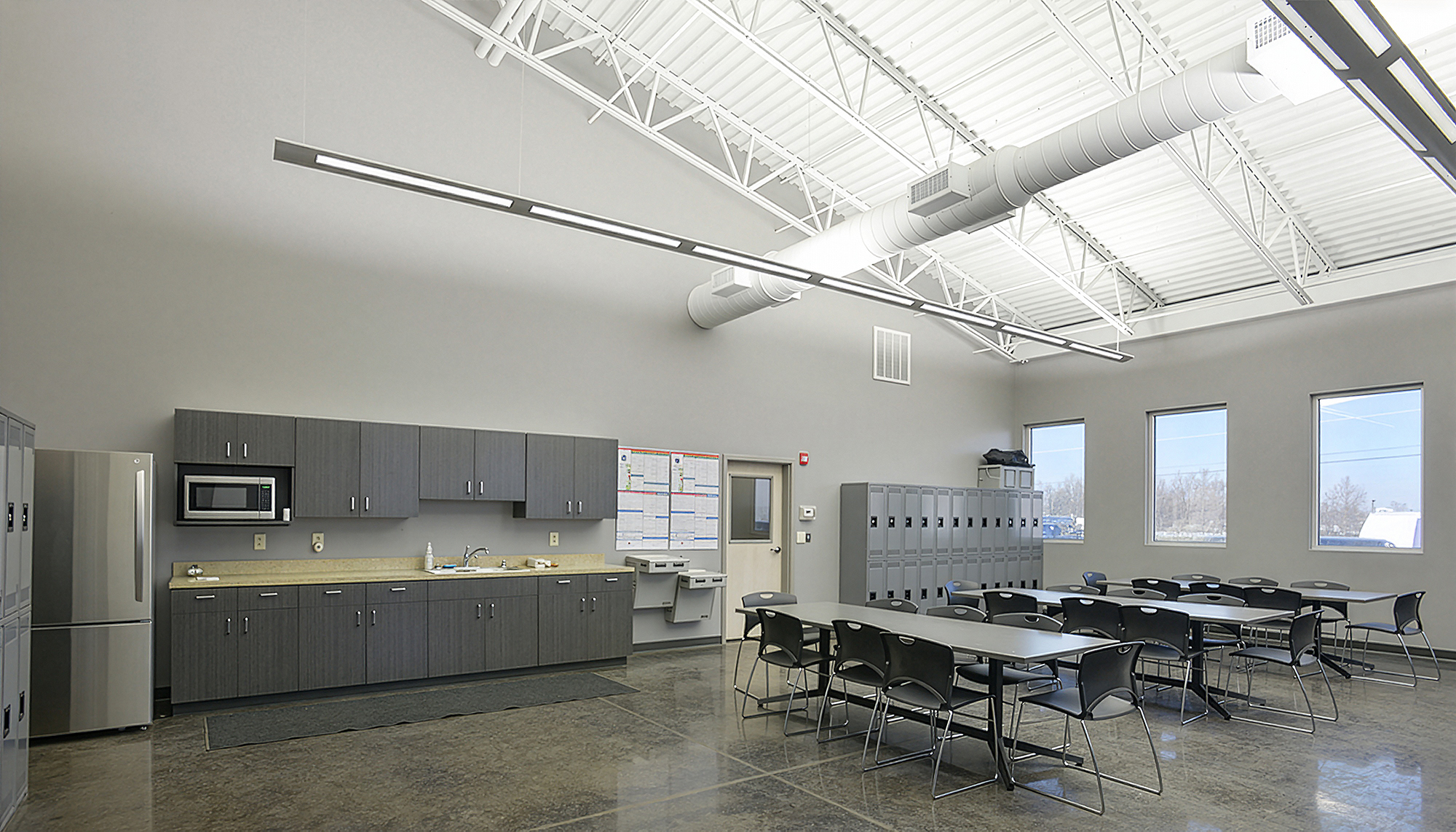 Employee breakroom and gathering area at the Harbor Steel facility featuring lockers, kitchenette space and shared seating.