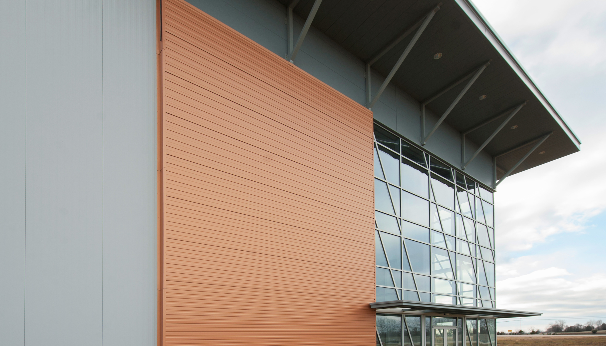 Architectural exterior detail of the Interstate Park Spec Building featuring integrated glazing, coordinated façade systems and an energy-efficient building envelope designed to support operational durability and a clean professional appearance.