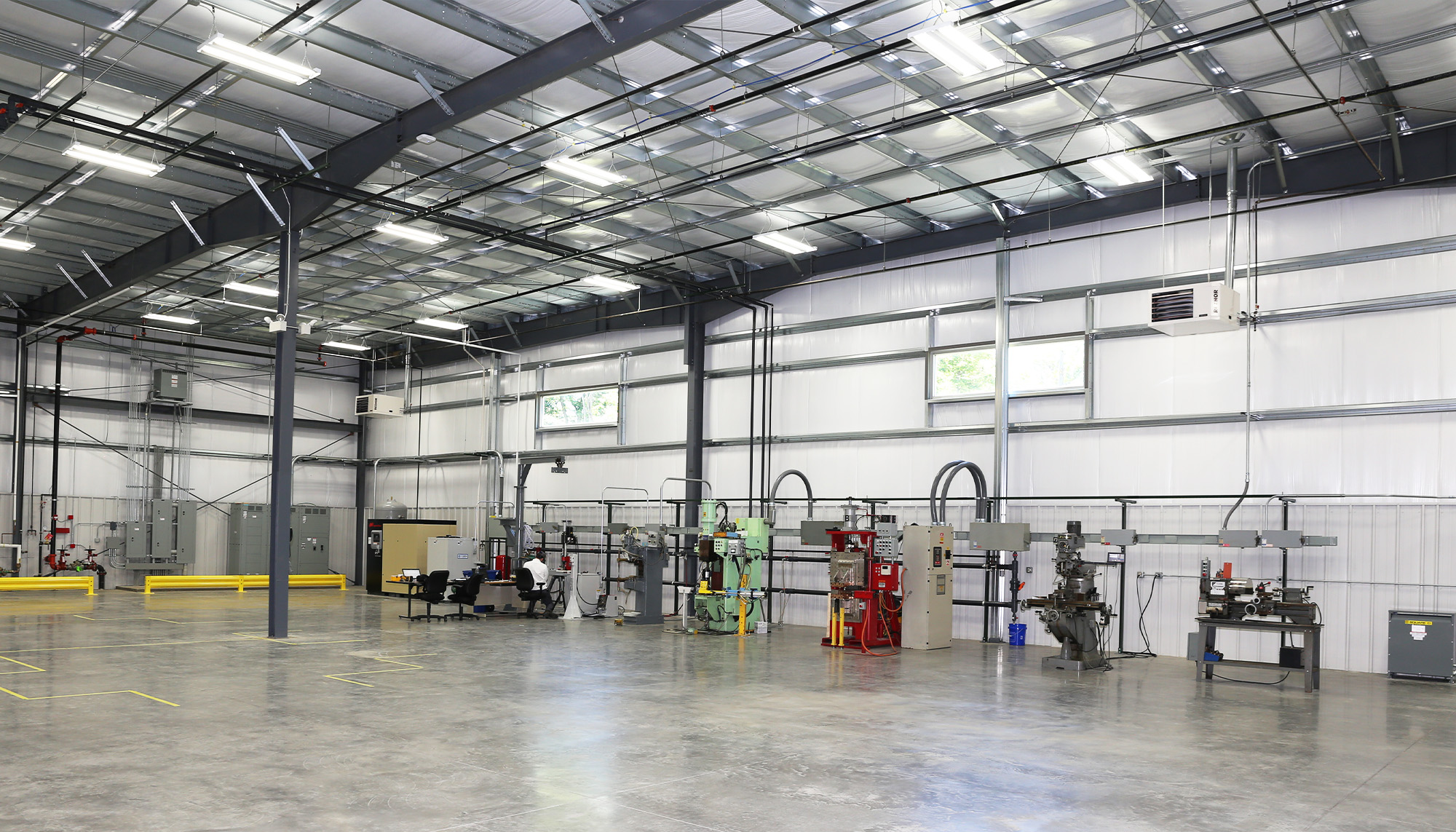 Manufacturing building interior with structural steel framing, high-bay industrial space and metal building systems.