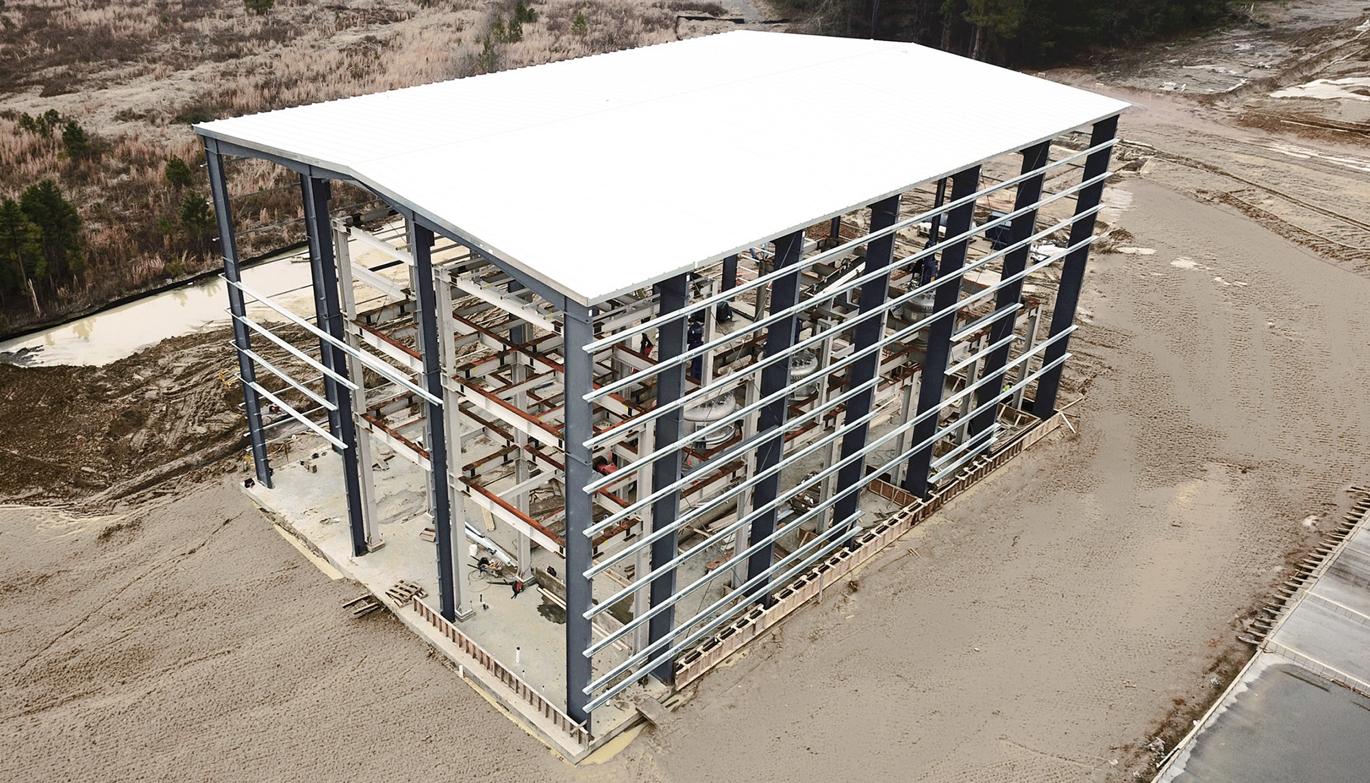 Structural framing under construction at the MIWON Specialty Chemicals USA facility showing a multi-level industrial building engineered to support coordinated manufacturing systems and phased campus development.
