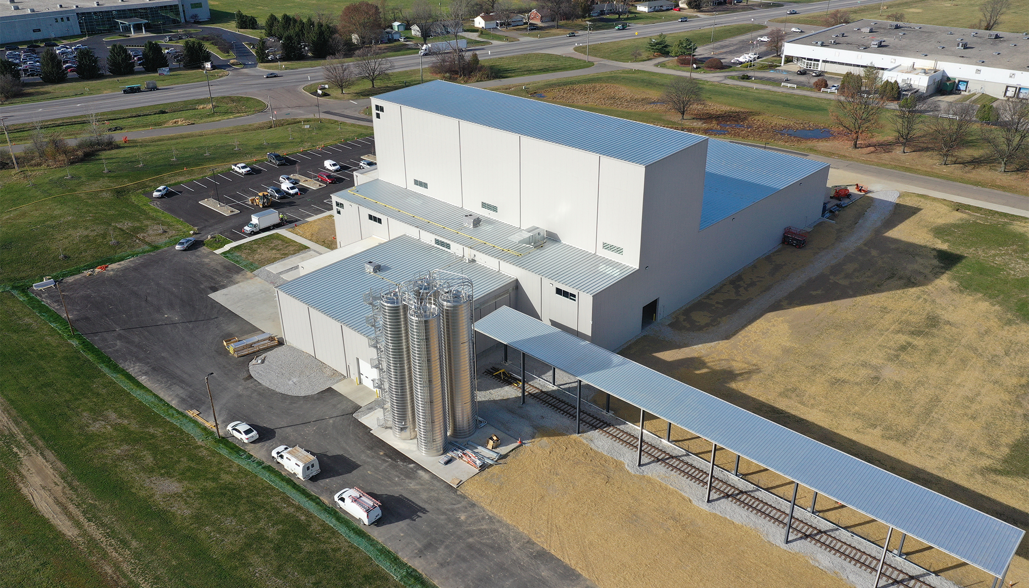 Aerial perspective of the Transcendia manufacturing facility featuring tall high-bay production space, integrated process infrastructure and coordinated logistics systems designed to support specialized manufacturing operations and future expansion.