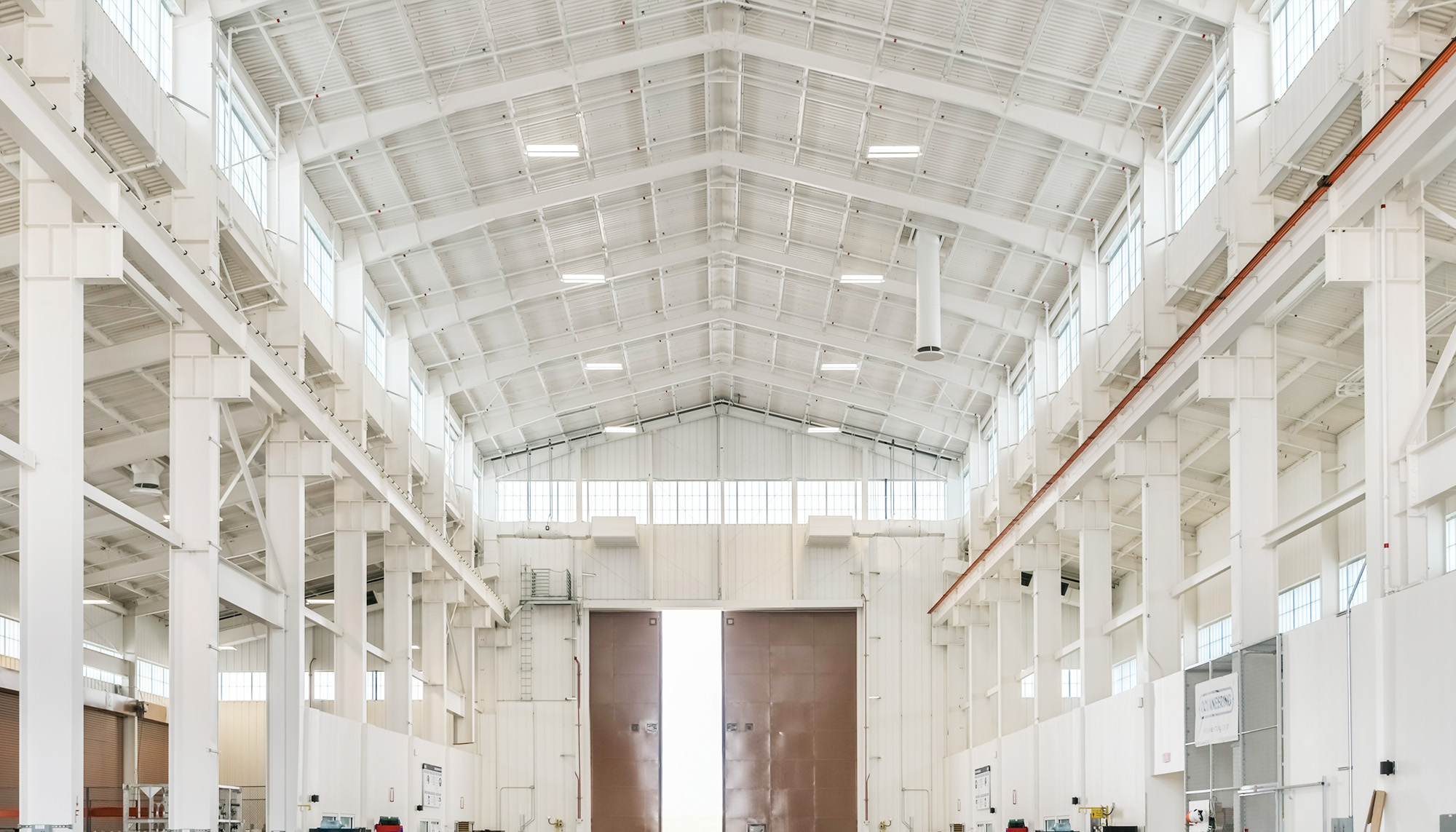 Undersea Rescue Command facility interior with clear span steel framing, high-bay production space and overhead crane support structure.