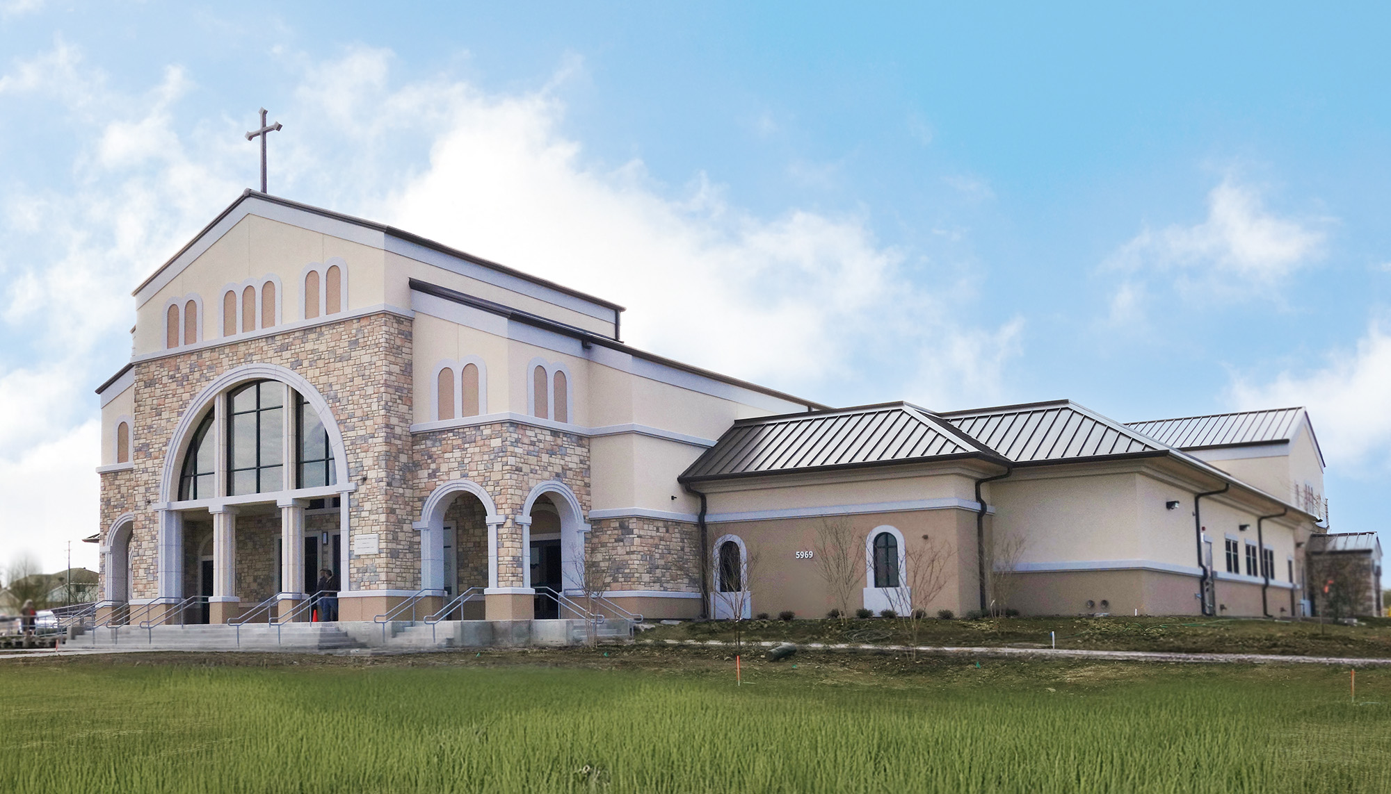 St. Thomas the Apostle Catholic Church building featuring stone veneer facade, standing seam roof system and steel-framed worship facility construction.