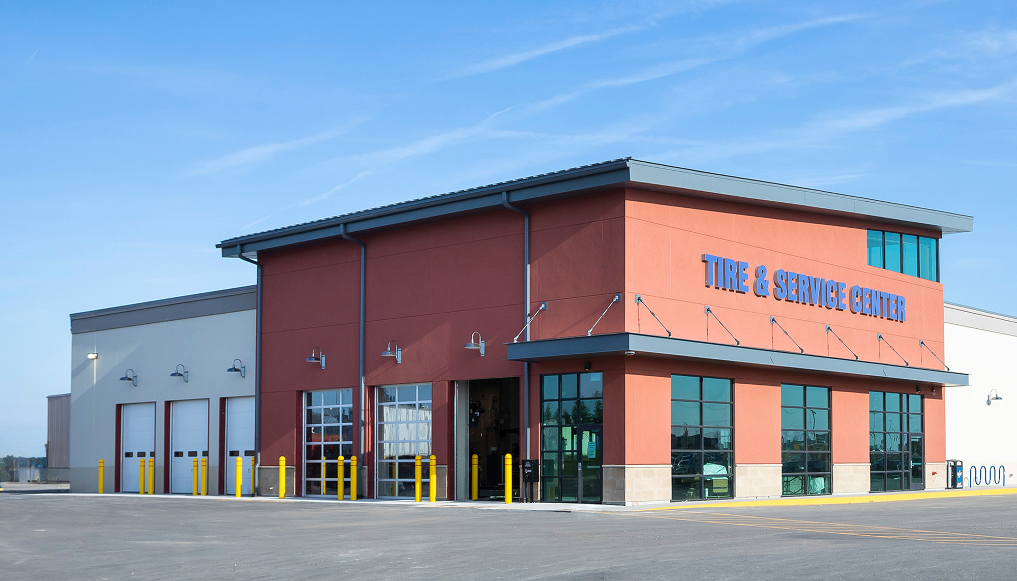 Exterior view of the Blain’s Farm & Fleet tire and service center featuring integrated vehicle service bays, customer access and a durable retail support environment designed for high-traffic operational efficiency.