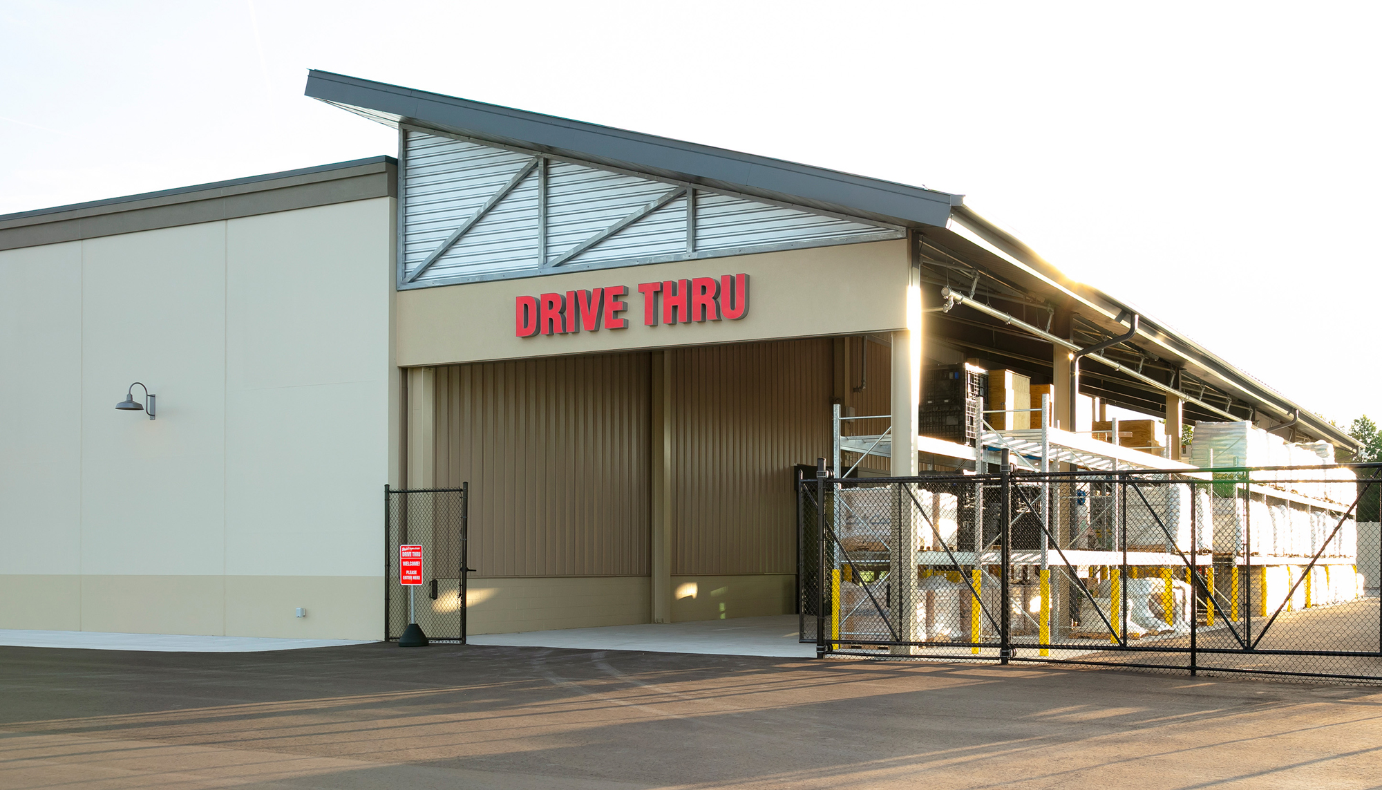 Exterior drive-thru service area at the Blain’s Farm & Fleet retail facility featuring integrated vehicle access, covered operational space and durable building systems designed to support efficient high-volume customer service.