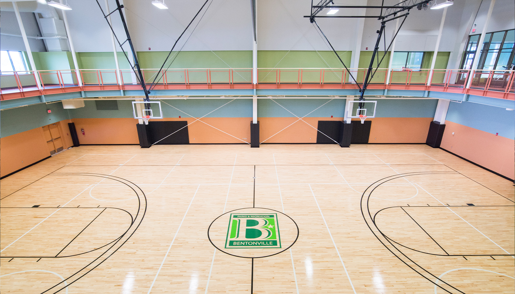 Interior of community center featuring clear span steel framing, hardwood basketball court and multi-purpose recreation facility.