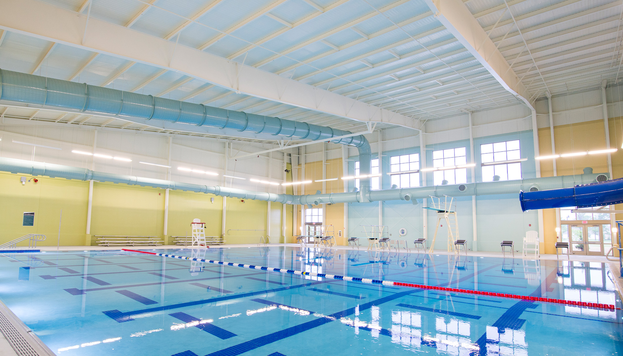 Indoor aquatic center featuring clear span steel framing, natatorium construction and competition swimming pool facility.
