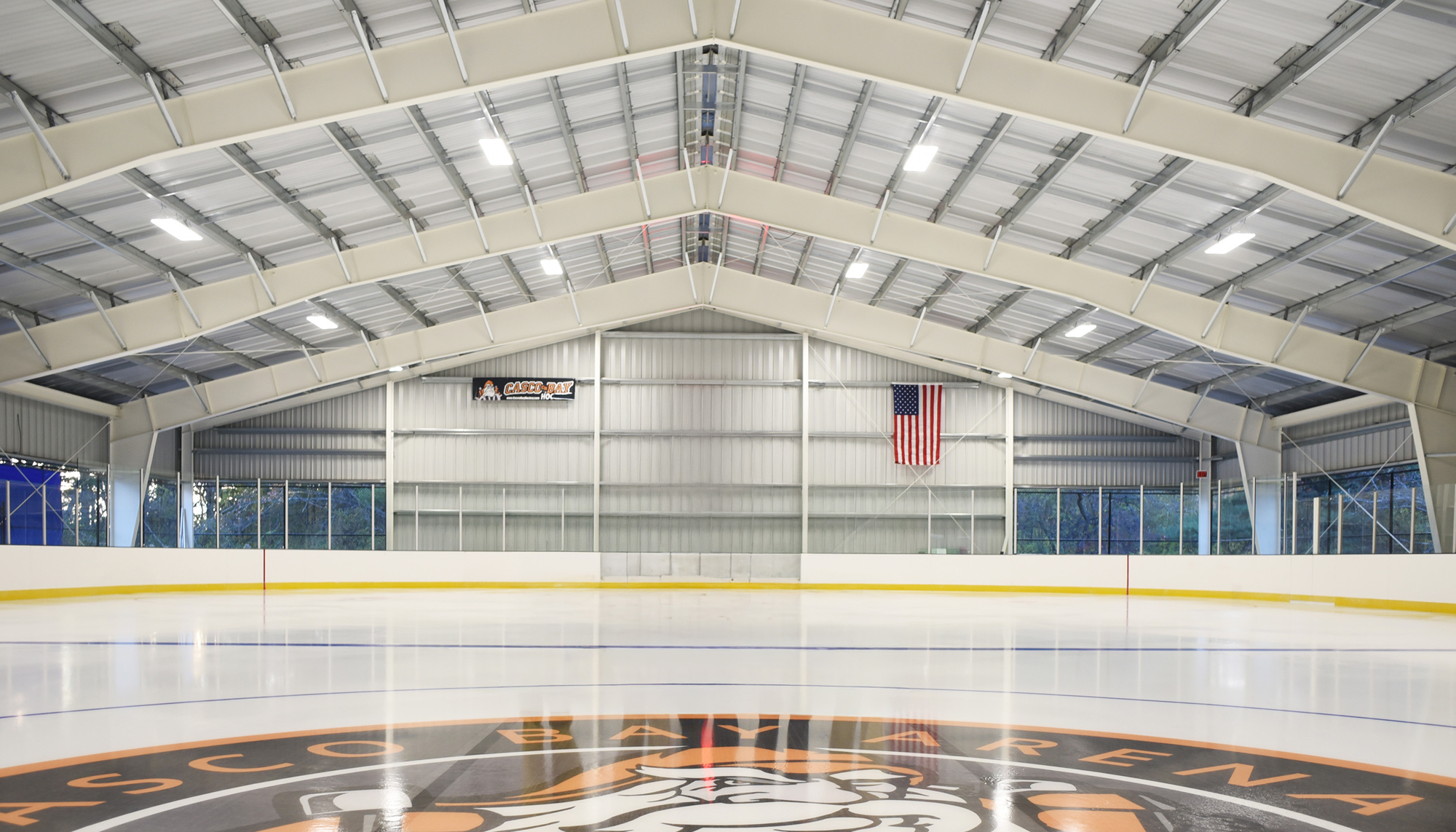Interior view of Casco Bay Arena featuring an open-span community ice rink designed to support consistent ice conditions, year-round hockey programming and energy-efficient operation through coordinated ventilation systems.