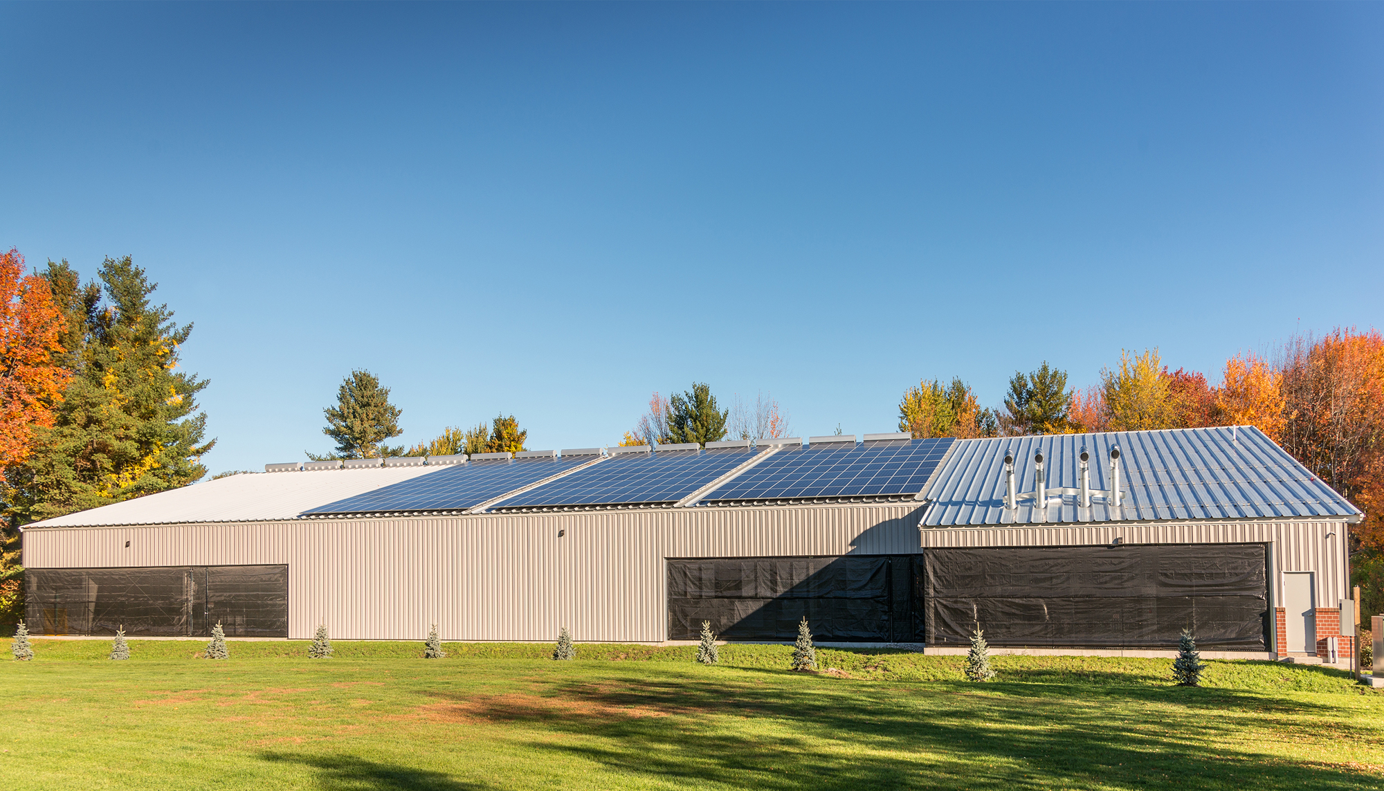 Exterior rear view of Casco Bay Arena featuring integrated ventilation and daylighting elements designed to support energy-efficient ice rink performance, reduced operating costs and year-round community use.