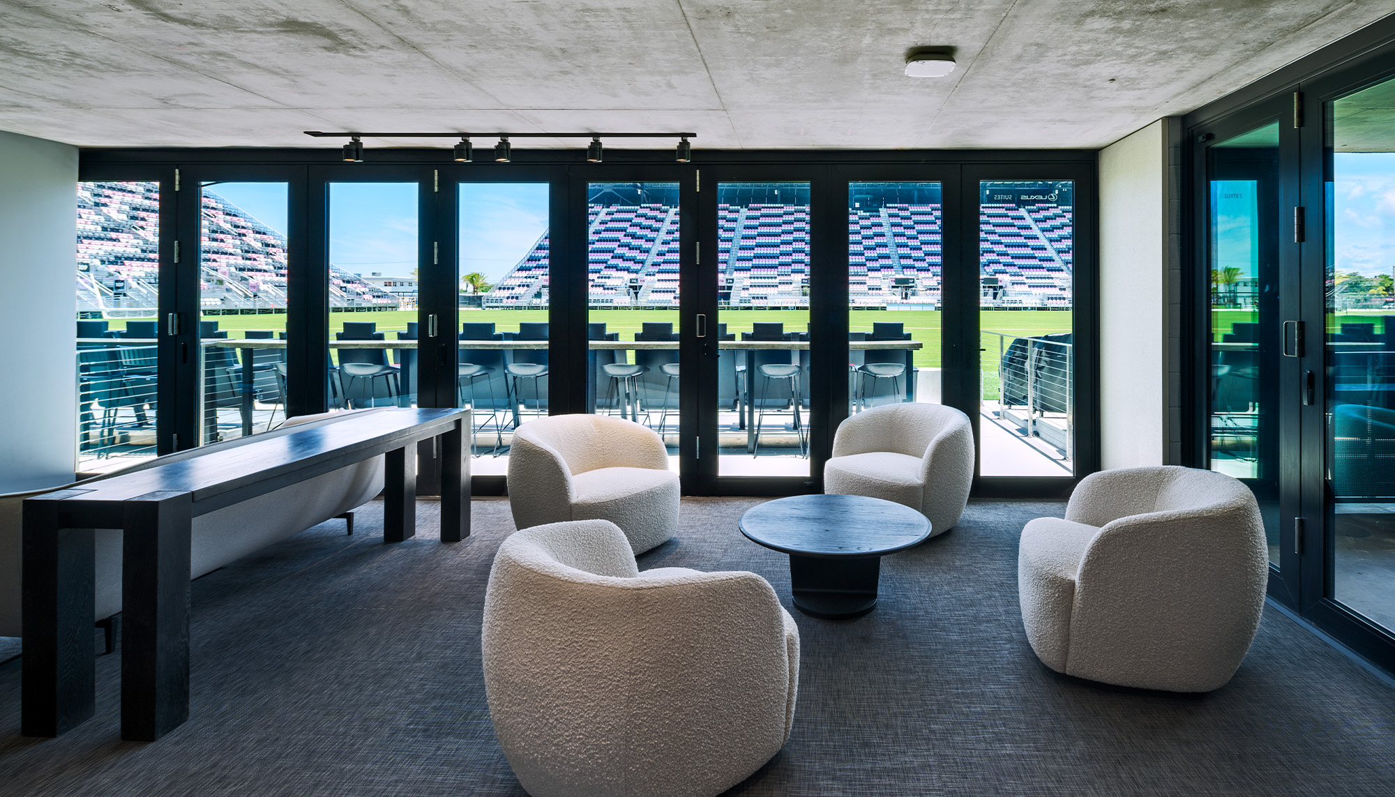 Inter Miami CF Training Facility lounge with hospitality seating and curtain wall glazing.