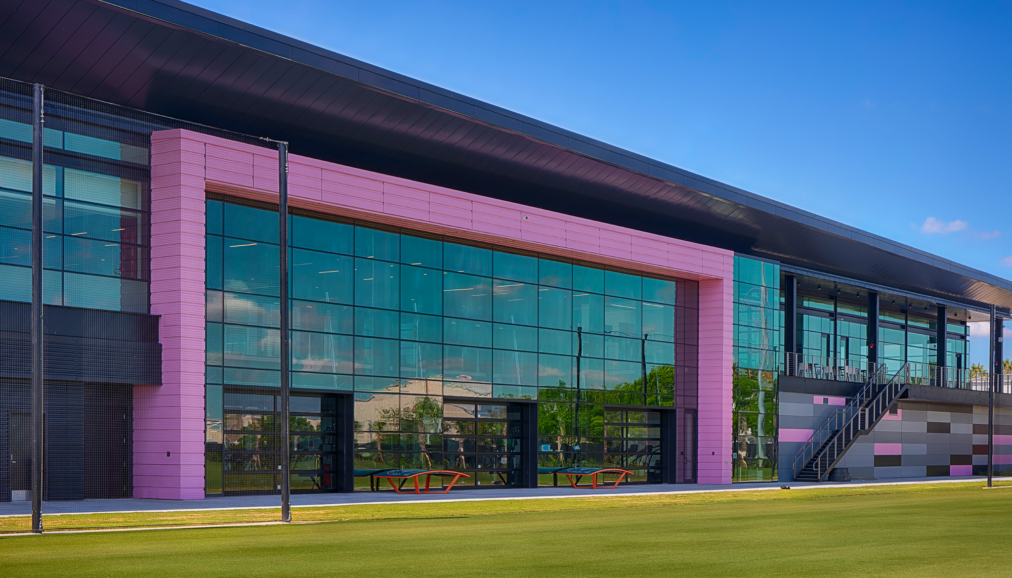 Inter Miami CF training center with expansive glass facade, steel building construction and elite athletic facility development.