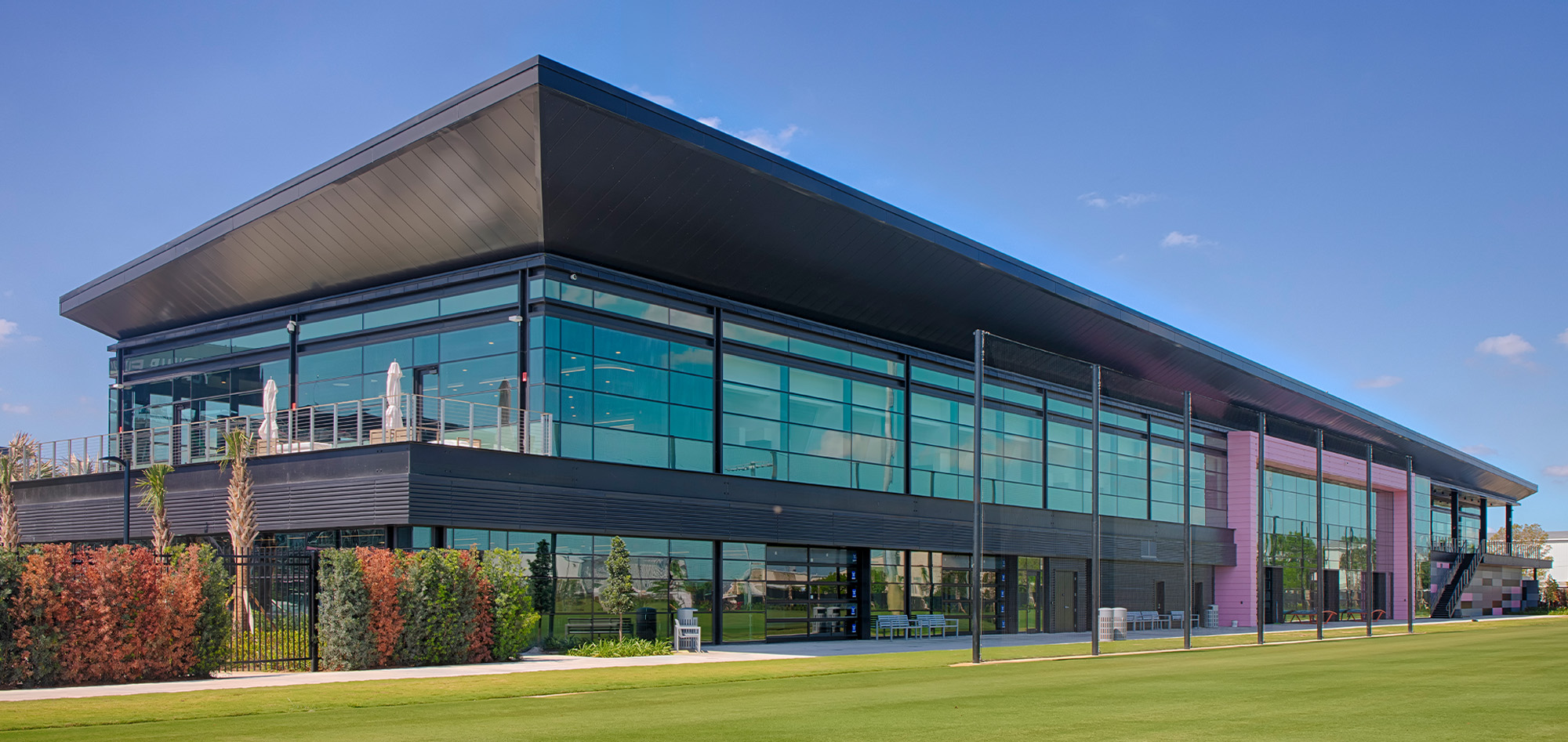 Inter Miami CF Training Facility featuring curtain wall glazing, architectural metal wall panels and professional sports training center construction.