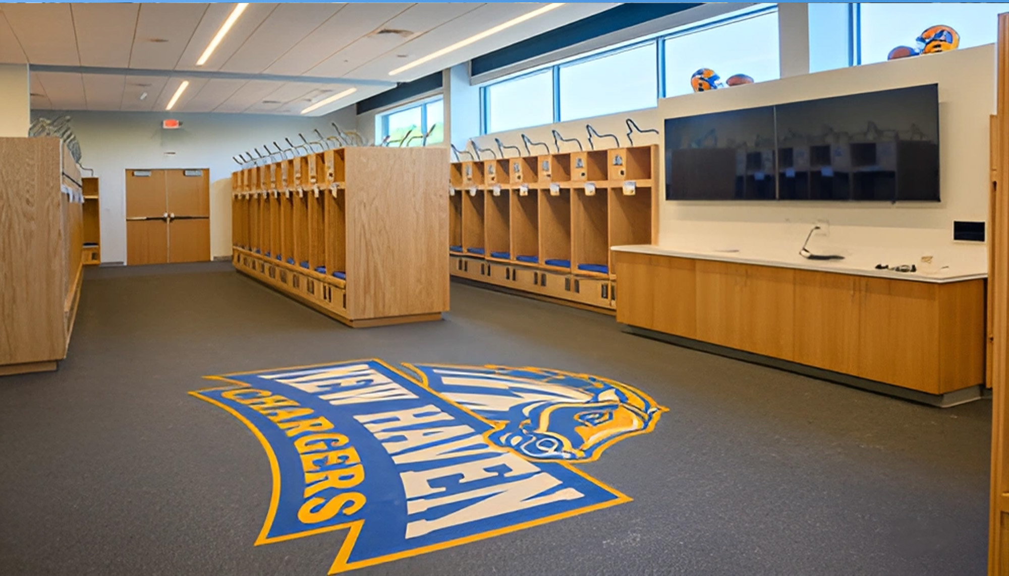 Athletic locker room featuring custom team lockers, sports facility amenities and recreation center interior design.